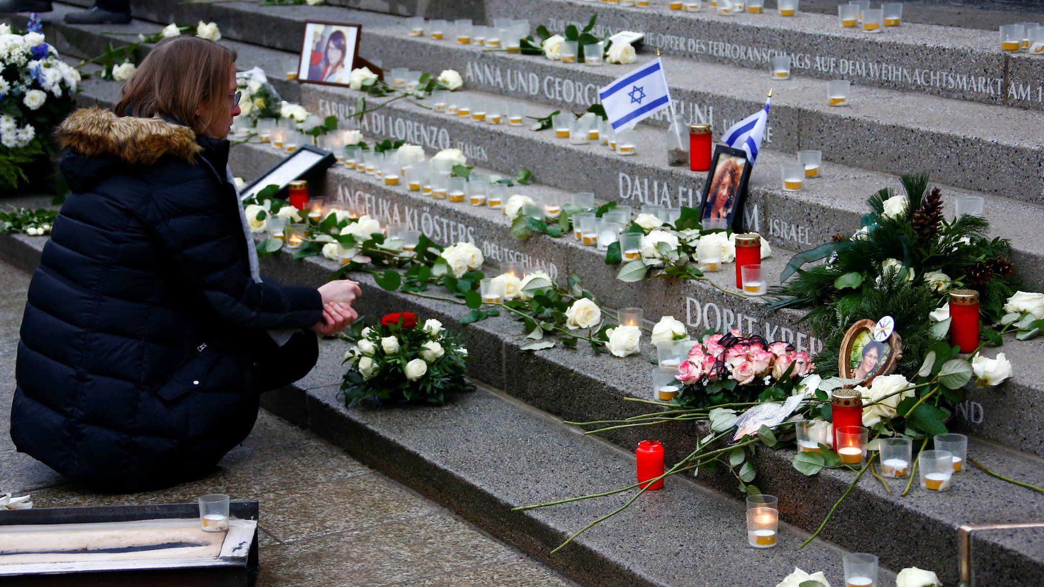 A woman mourns as she attends the inauguration of a memorial in Berlin