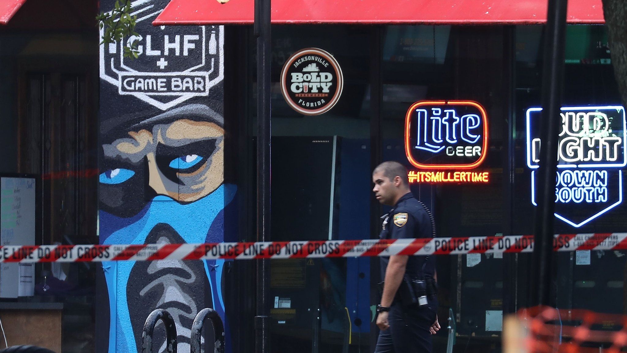 A Jacksonville Sheriff officer walks past the GLHF Game Bar on Monday morning, 27 August 2018