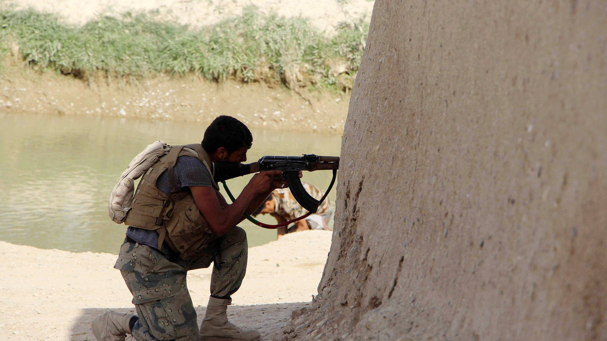 A member of the Afghan security service takes position during an operation in an area retaken from the Taliban, in Nawa district of Helmand province, Afghanistan, 18 April 2017