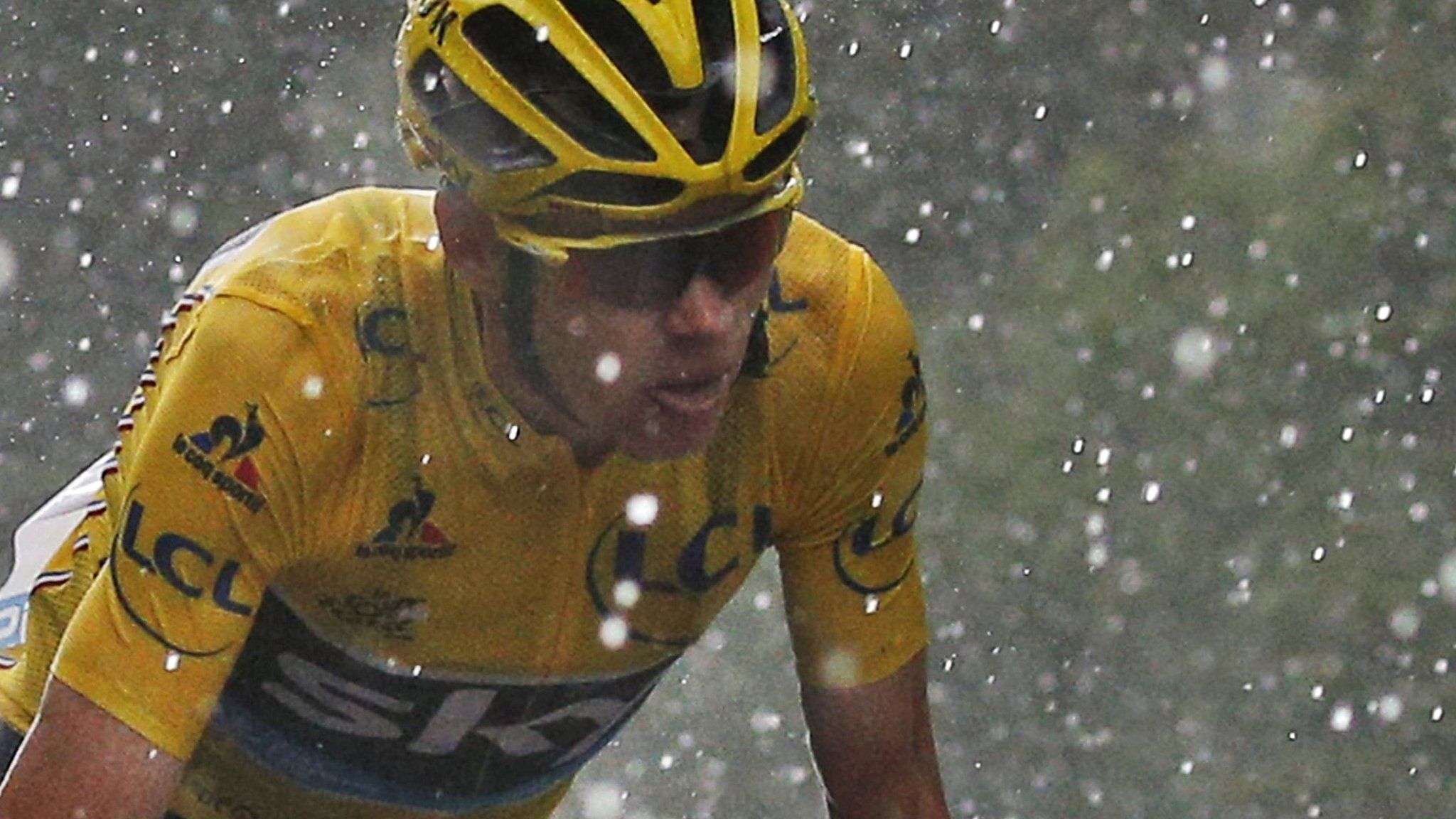 Chris Froome battles through the rain and hail