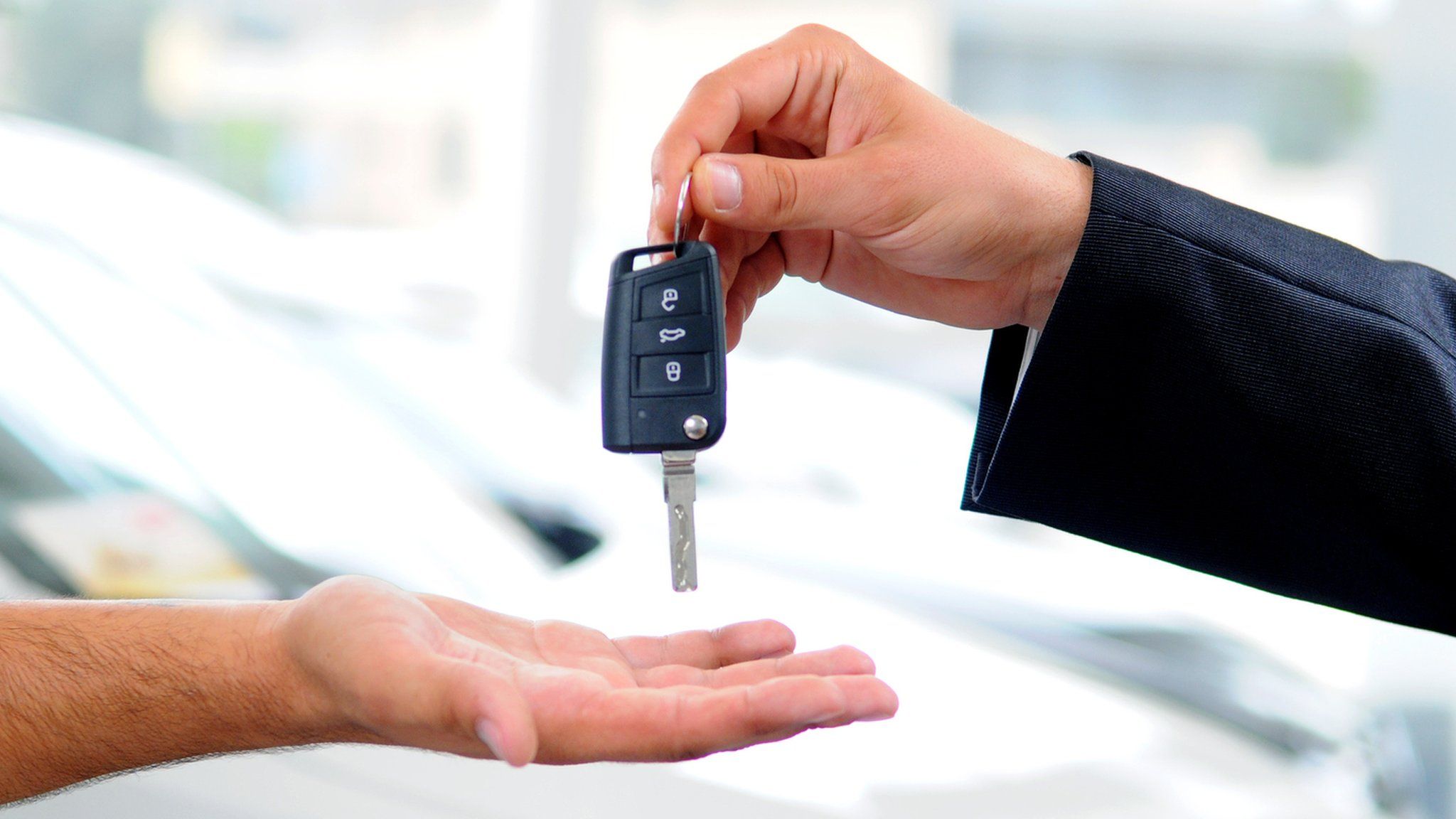 Salesman hands over car key