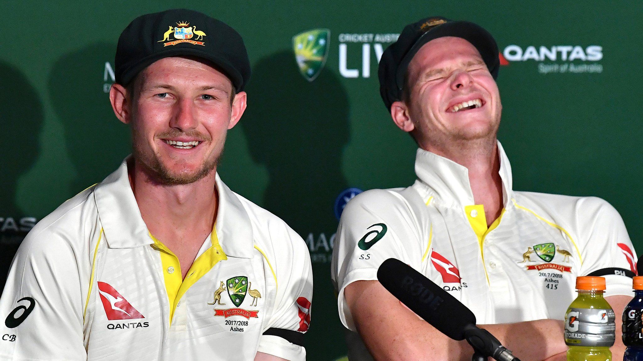 Australia's Cameron Bancroft and Steve Smith laugh during a news conference after the first Test