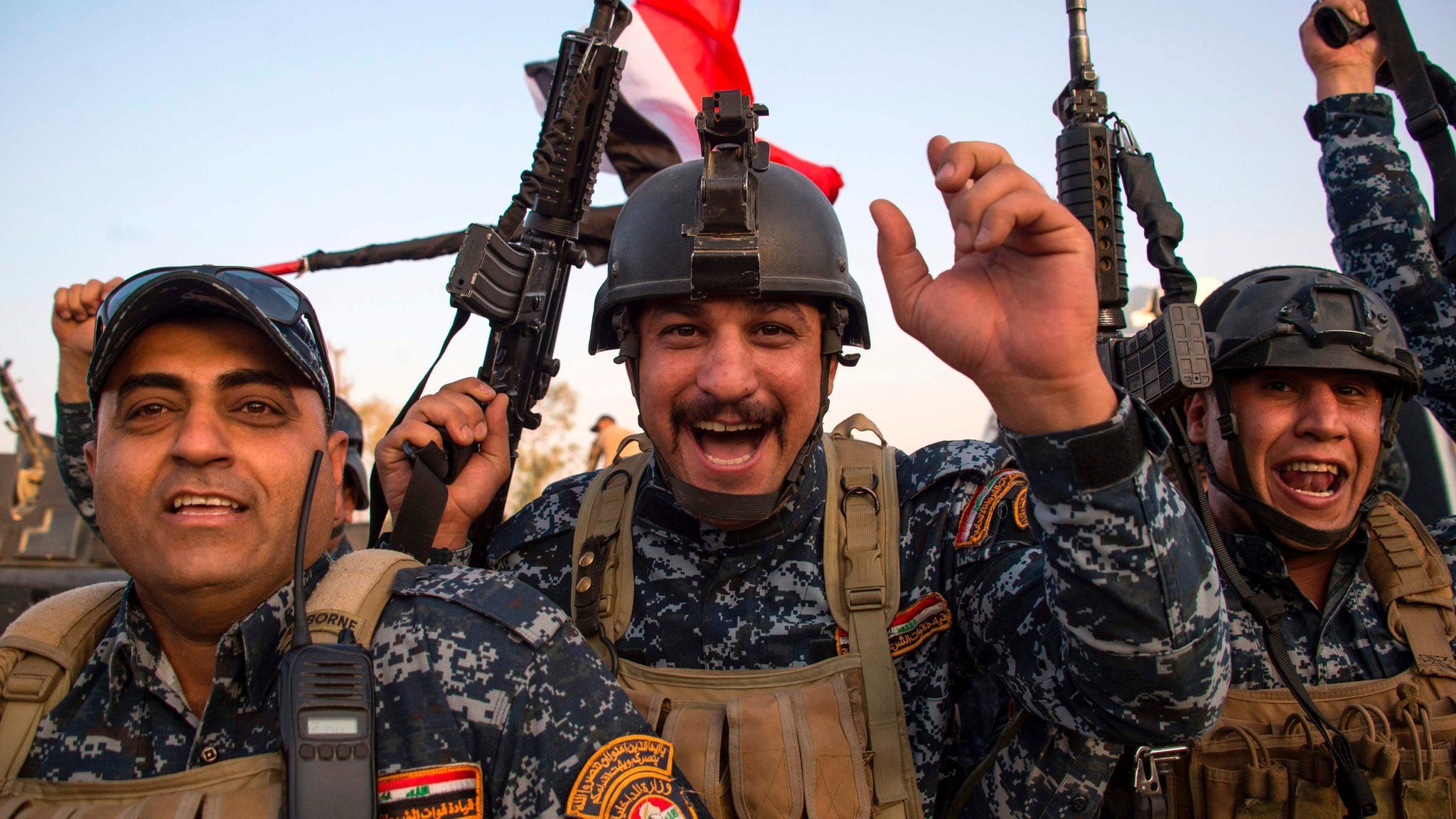Members of the Iraqi federal police celebrate in the Old City of Mosul on 10 July 2017