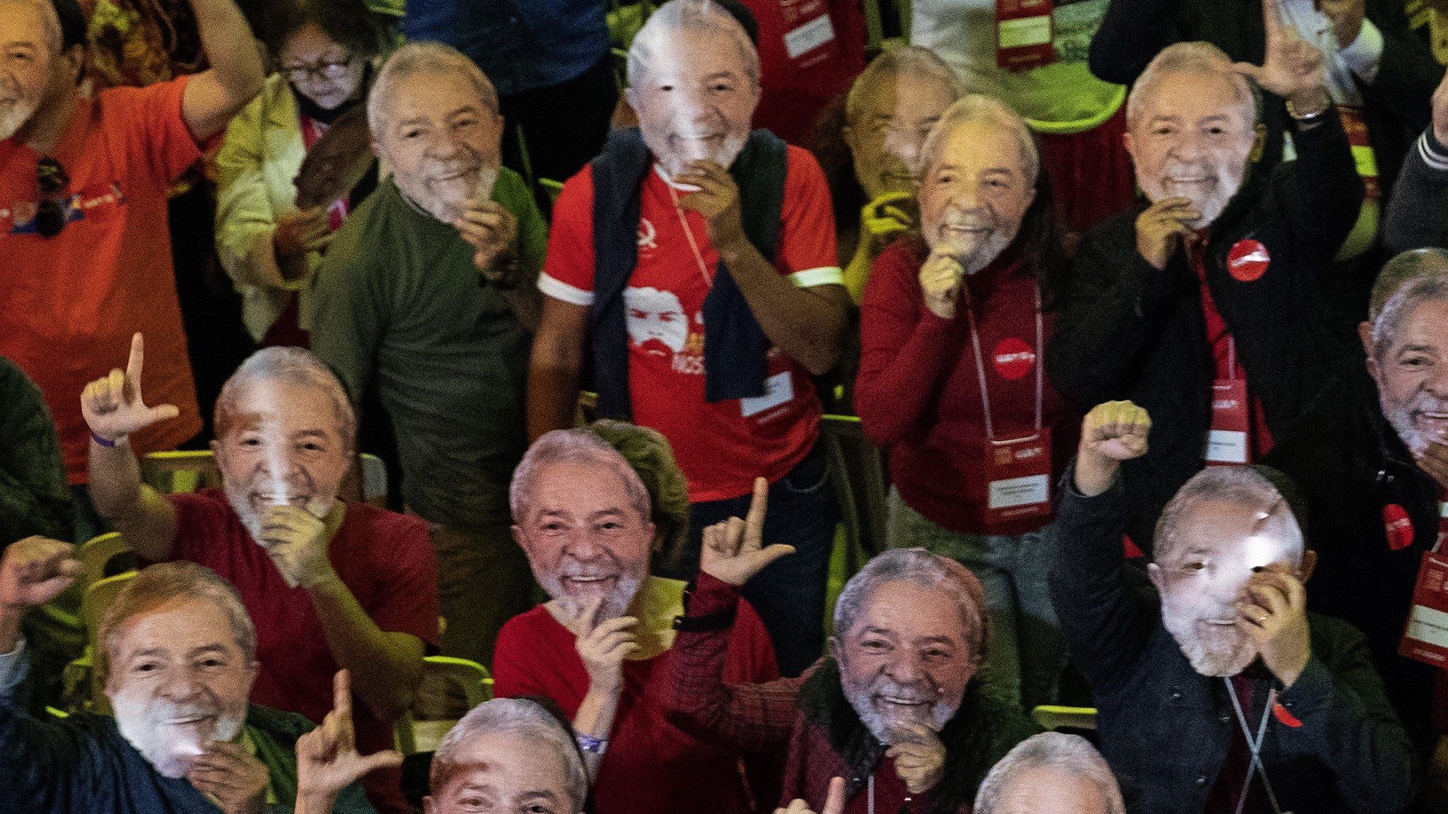 Supporters of former Brazilian President Luiz Inacio Lula da Silva wear masks