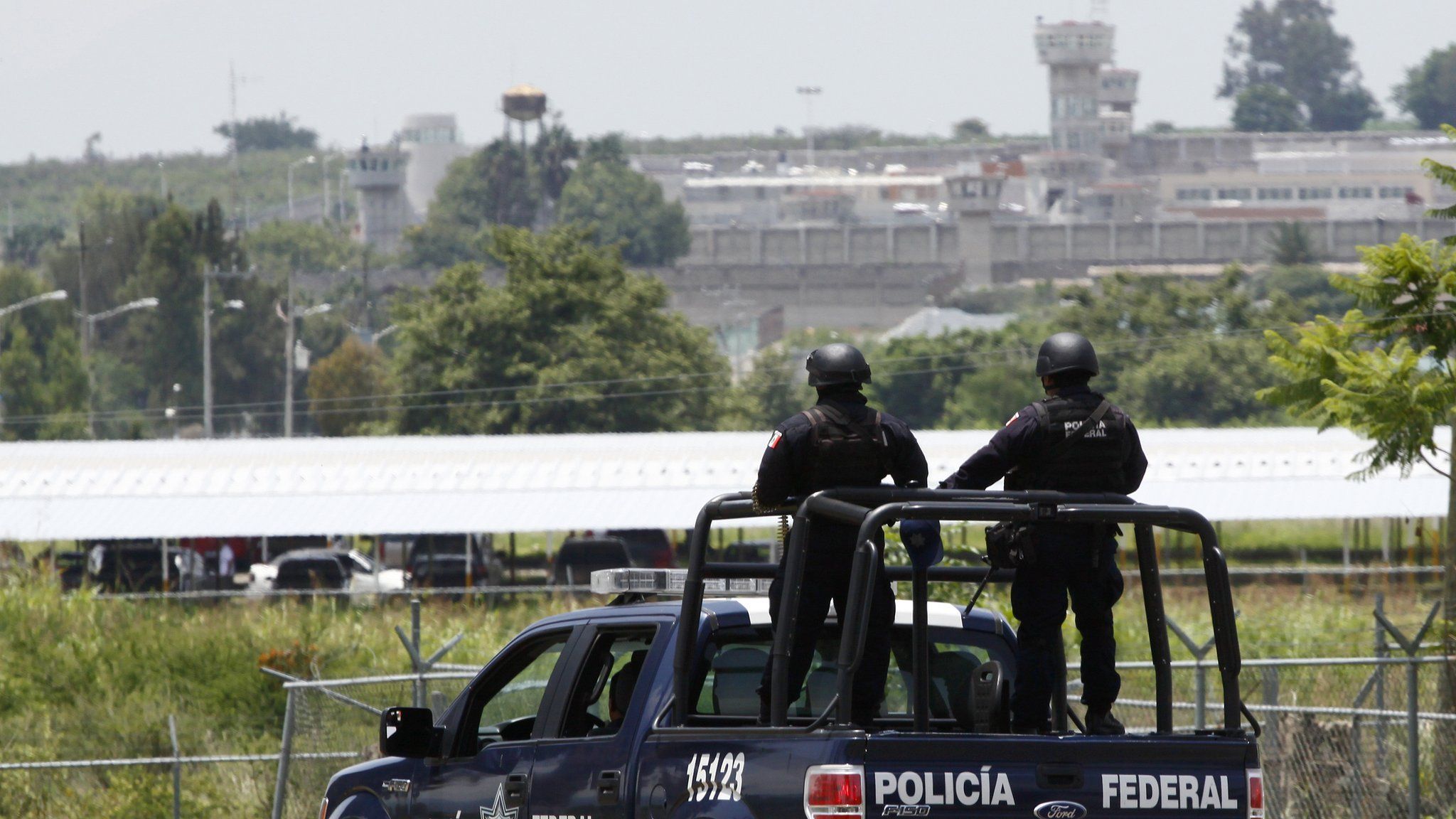 A unit of the Mexican Federal Police patrols the surroundings of the Puente Grande State prison (background) in Zapotlanejo, Jalisco State, Mexico, on 9 August,