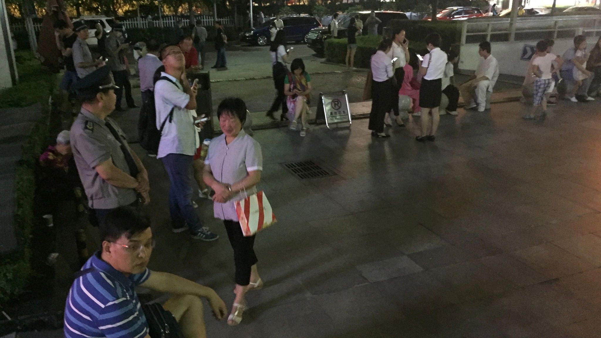 Residents gather outside buildings in Xian, China, on 8 August 2017