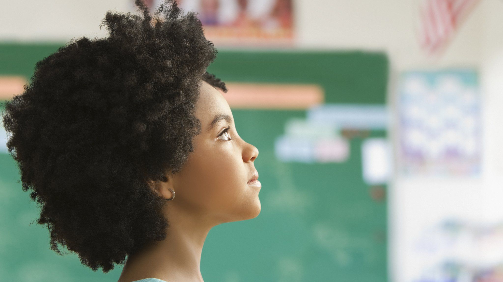 Girl with afro hair in school classroom