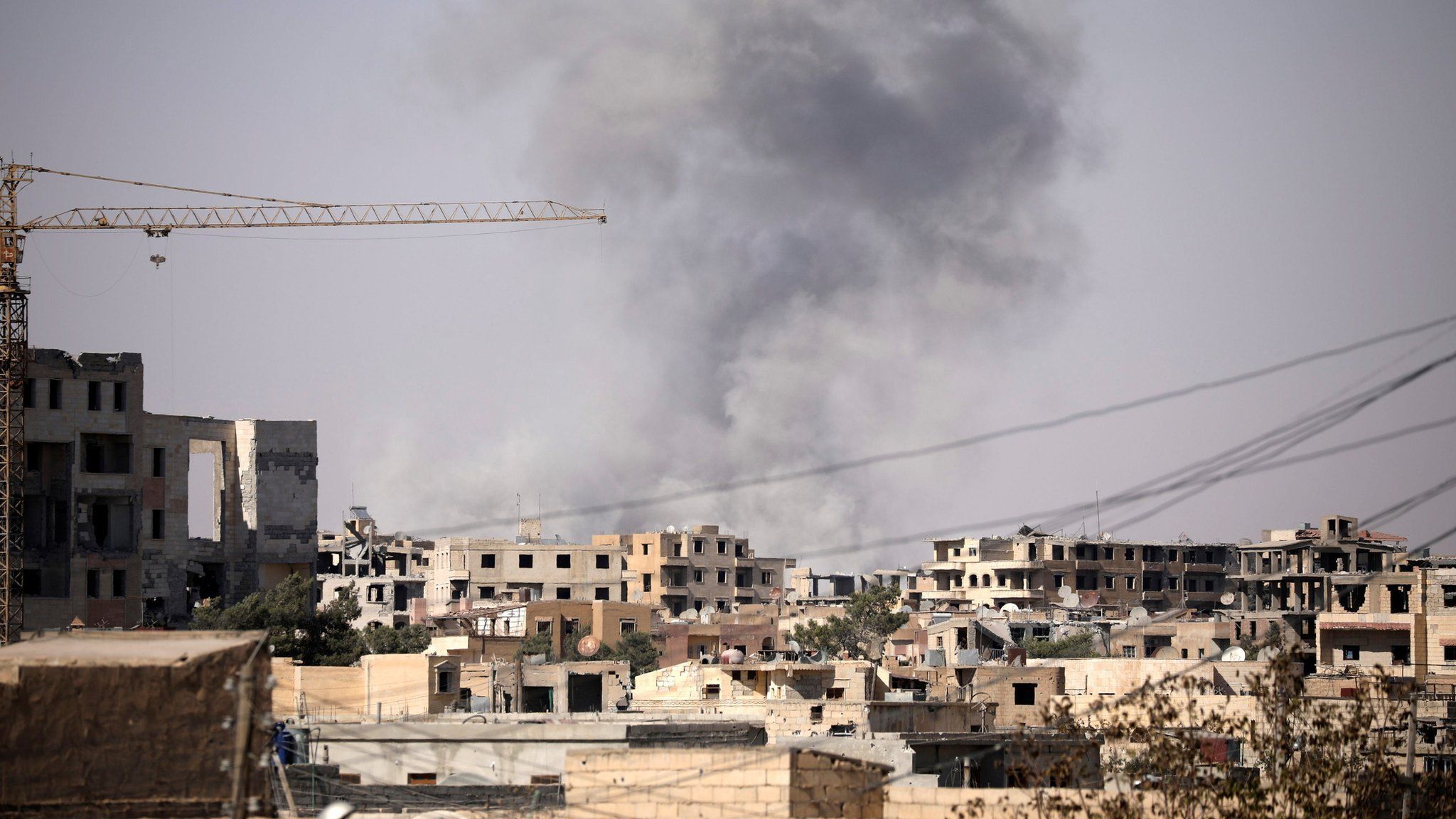 Smoke rises from a building in Raqqa on 31 July