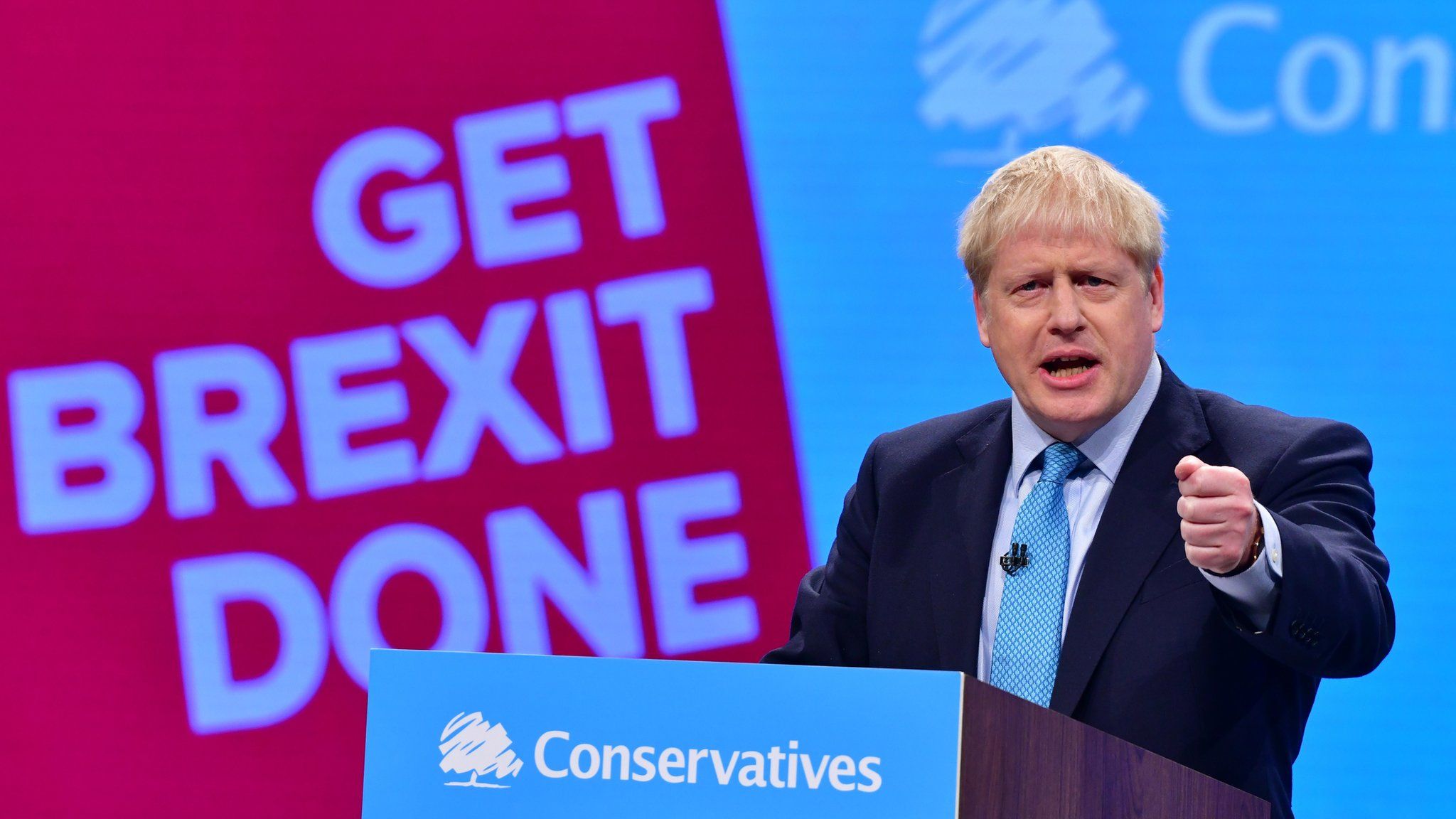 Boris Johnson at Conservative Party Conference in front of "Get Brexit Done" sign
