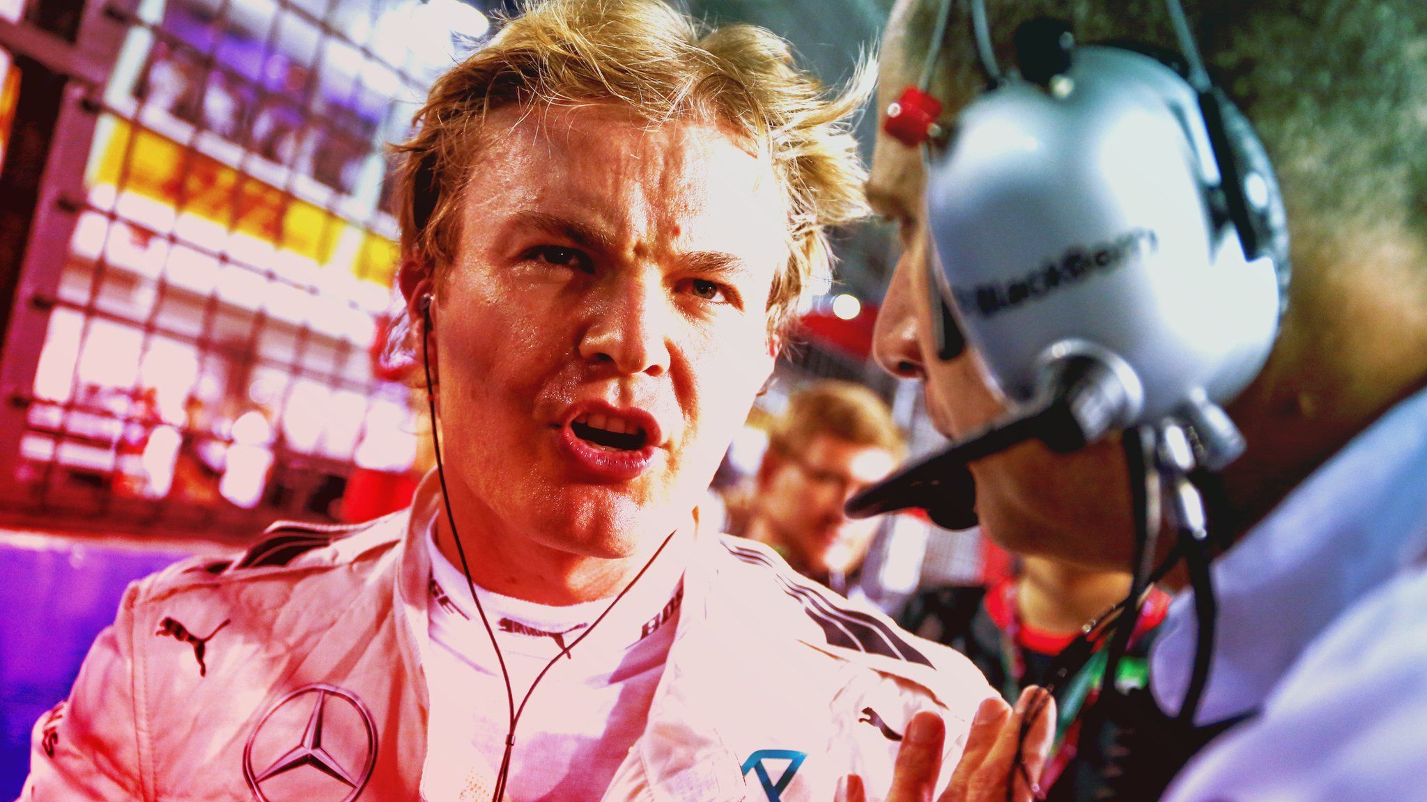 Grumpy Rosberg removes his cap and shows his teeth