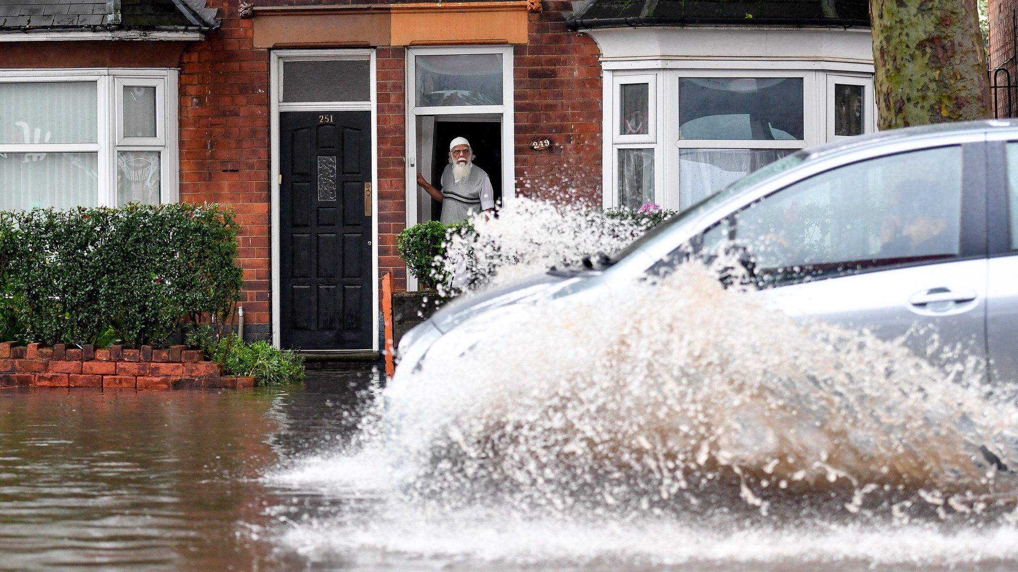 A car drives through floods in Alum Rock, Birmingham