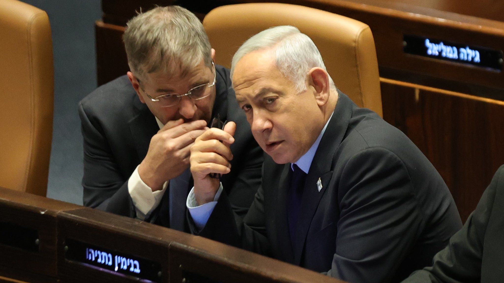 Israeli Prime Minister Benjamin Netanyahu (R) attends a voting session in the Knesset on 22 March 2023