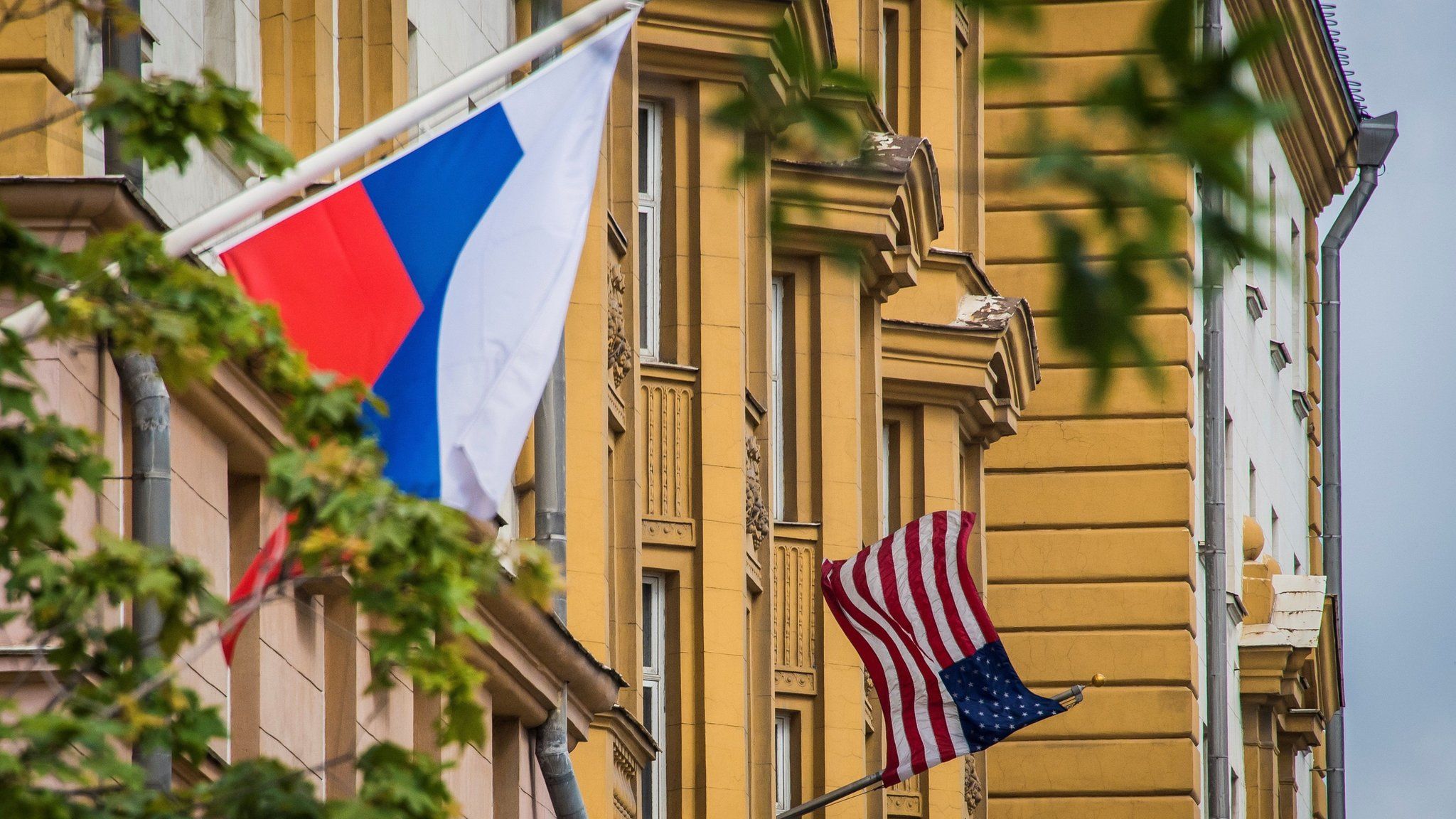 A Russian flag flies next to the US embassy building in Moscow on July 31, 2017
