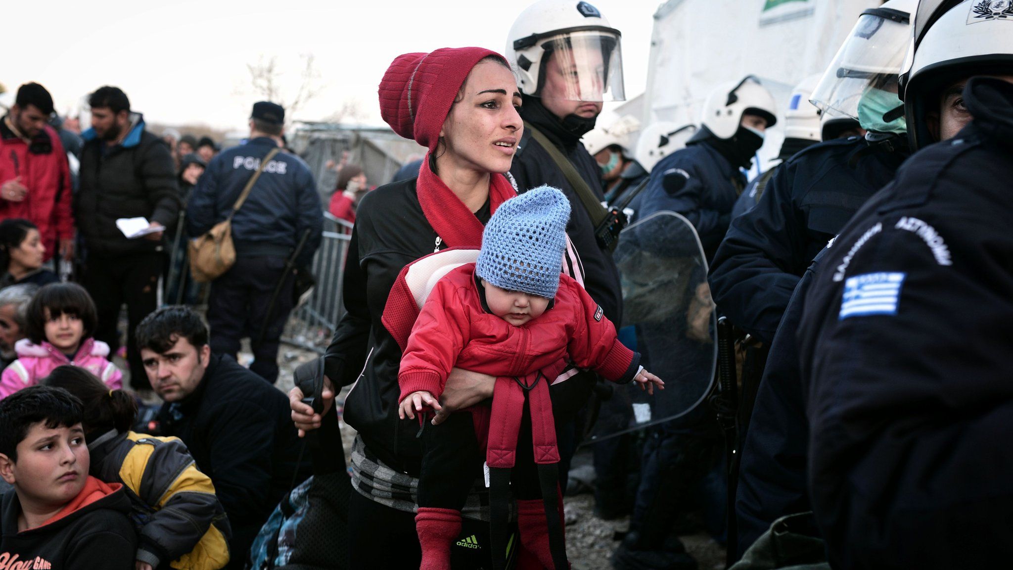 A woman looks for her husband and son as she is allowed to cross into Macedonia at the Greek-Macedonian border, near the Greek village of Idomeni. 2 March 2016