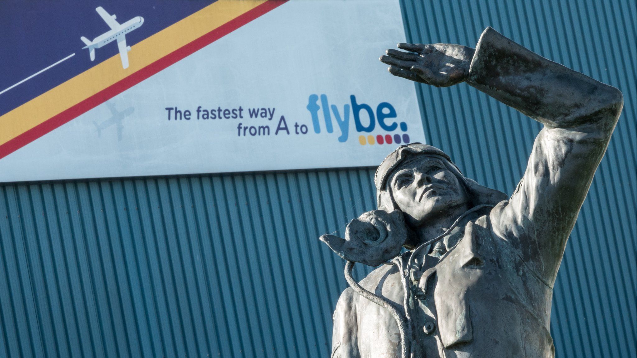 Aviator in front of Flybe sign