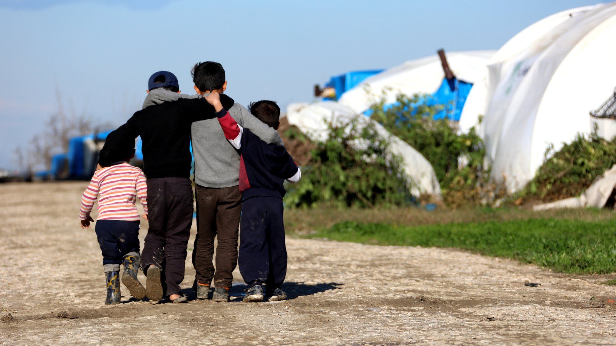 Syrian children hugging in a refugee camp