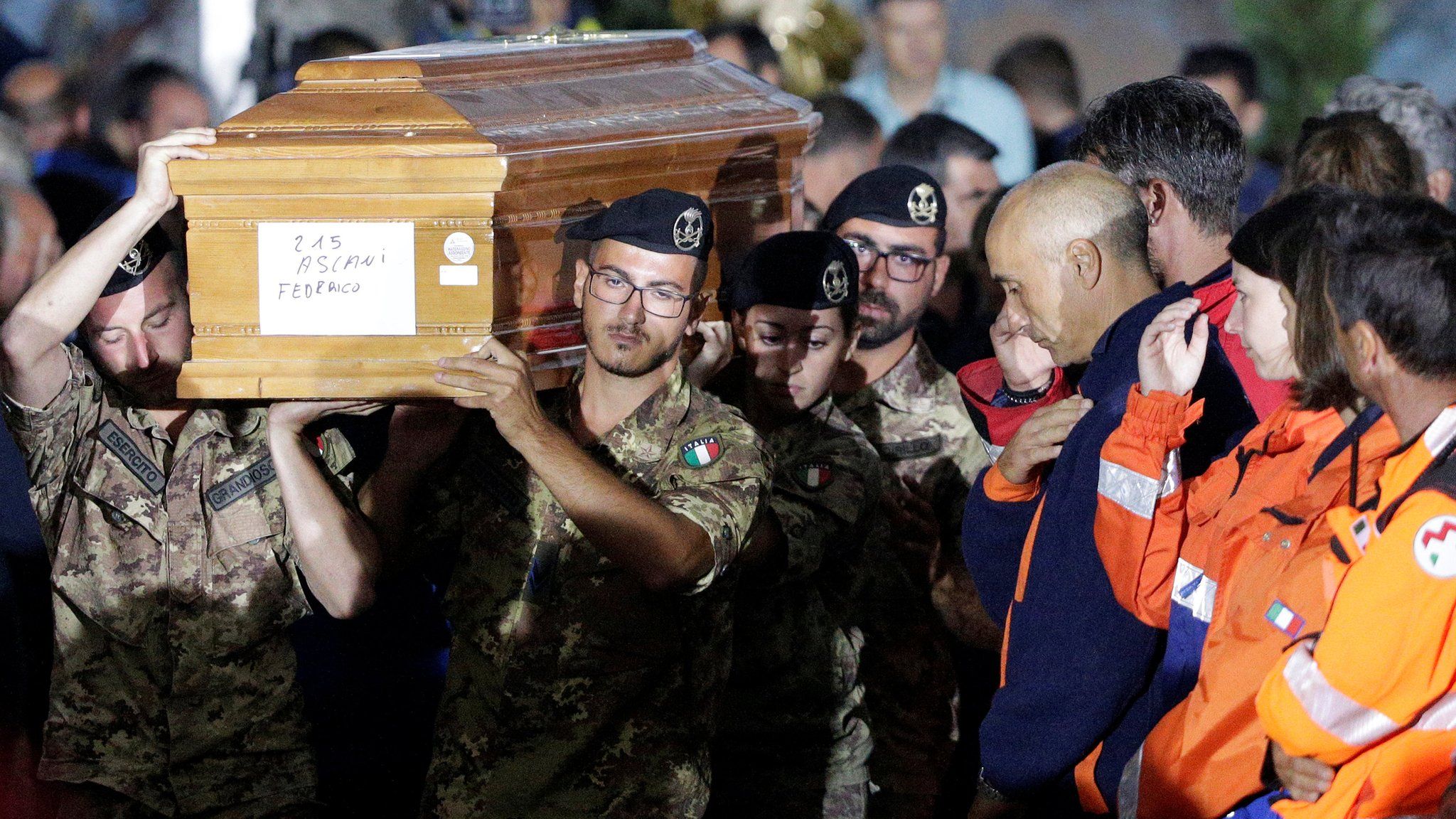 Italian soldiers carry coffin at funeral service for victims of earthquake in Amatrice, central Italy, August 30, 2016