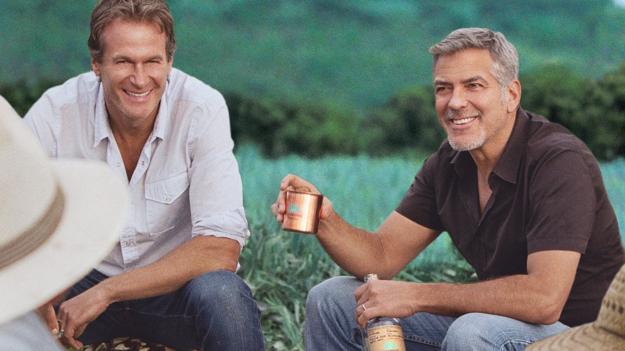 Rande Gerber and George Clooney in field of agave in promotional shot for Casamigos