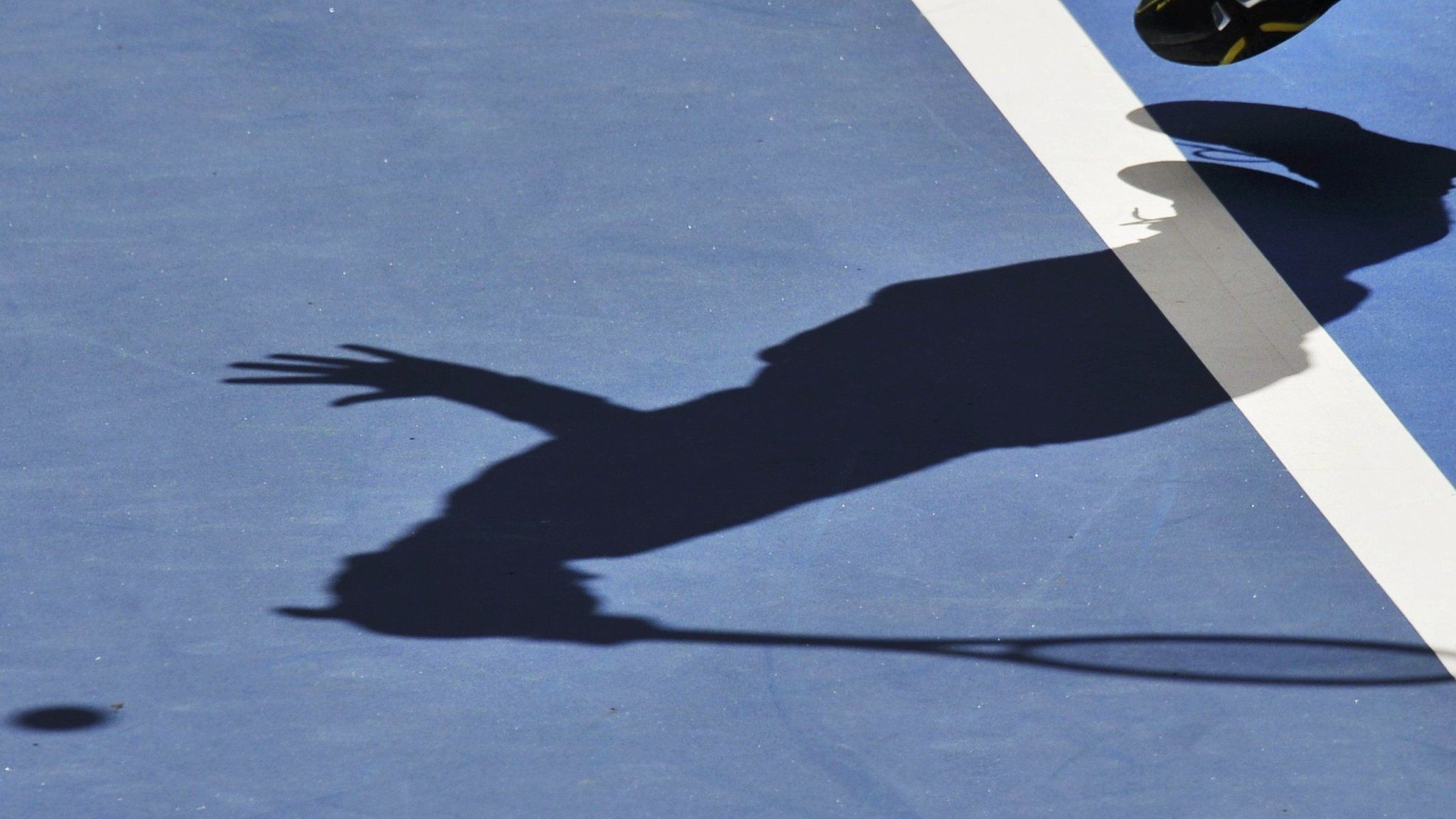Tennis player in shadow