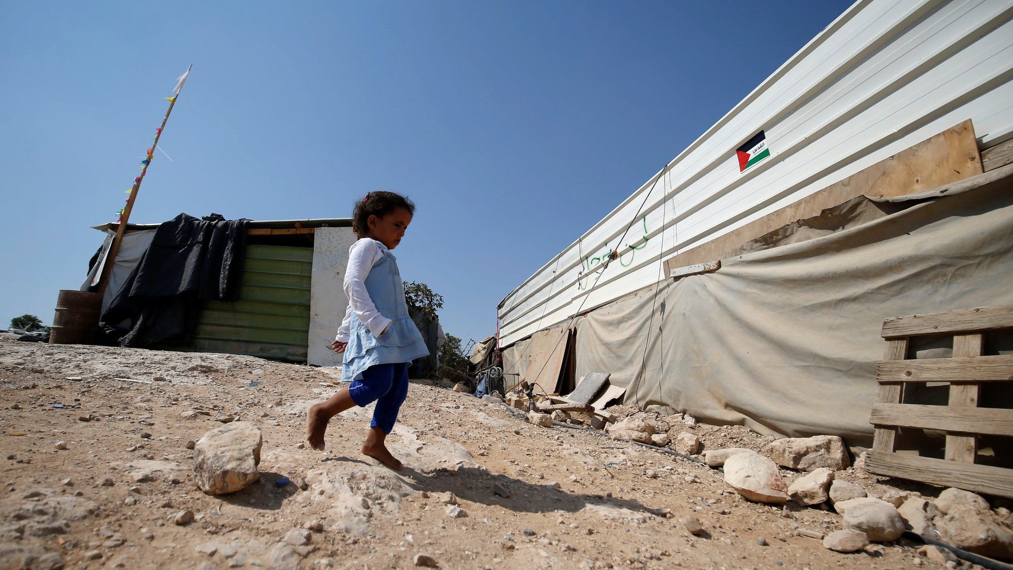 A girl walks outside her home in the Bedouin village of Khan al-Ahmar, in the occupied West Bank (5 September 2018)