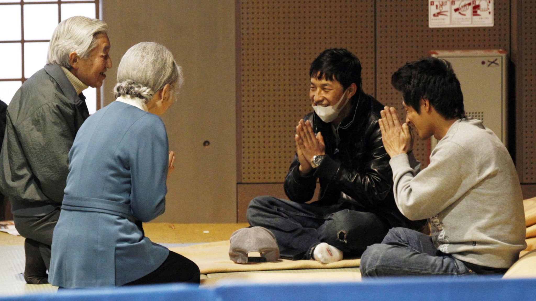 Emperor Akihito and Empress Michiko talk with evacuees from the 2011 earthquake and tsunami.