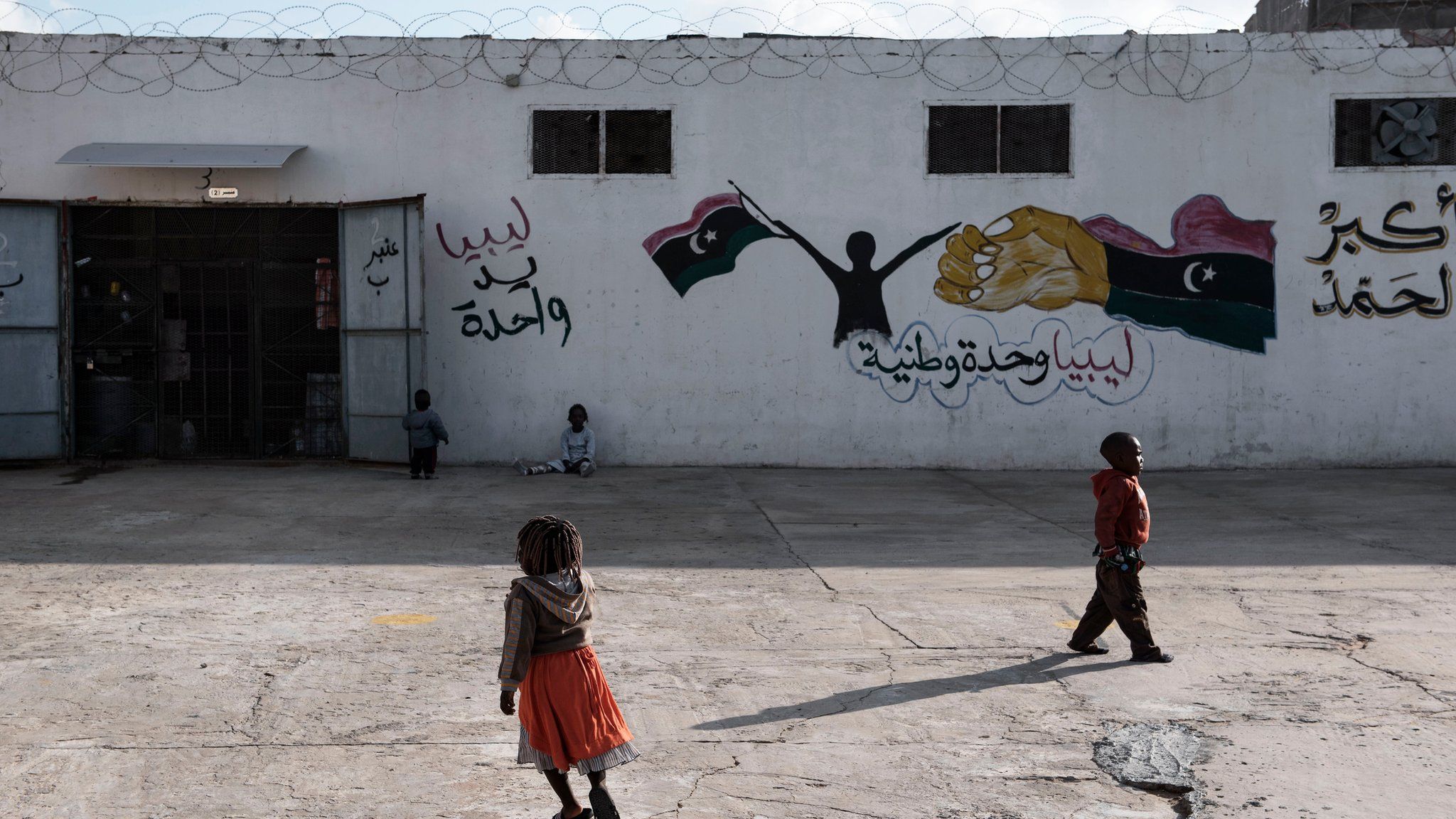 Migrant children walk outside a detention centre in Libya on 30 January 2017
