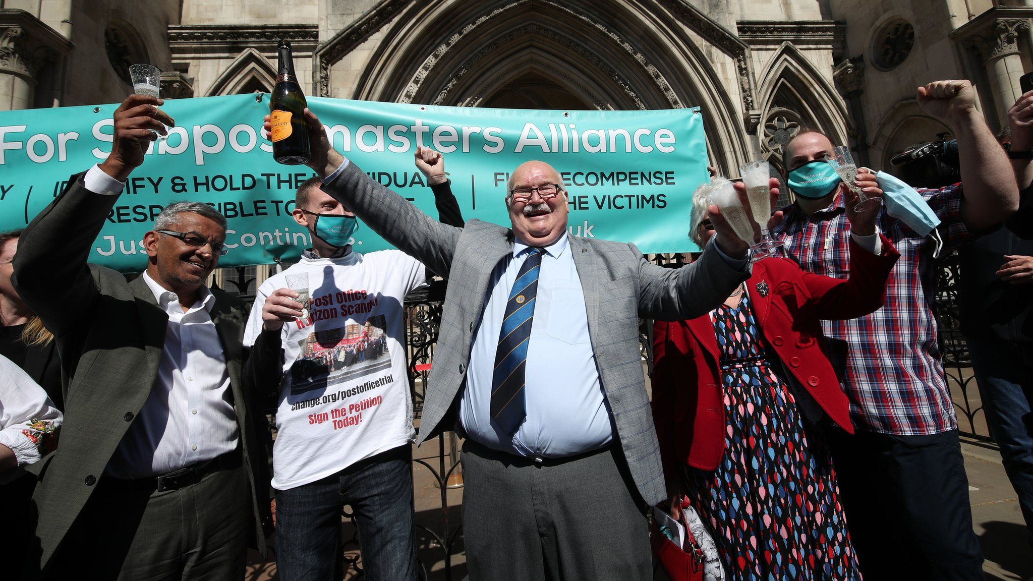 Former post office workers celebrate outside the Royal Courts of Justice, London, after having their convictions overturned by the Court of Appeal.