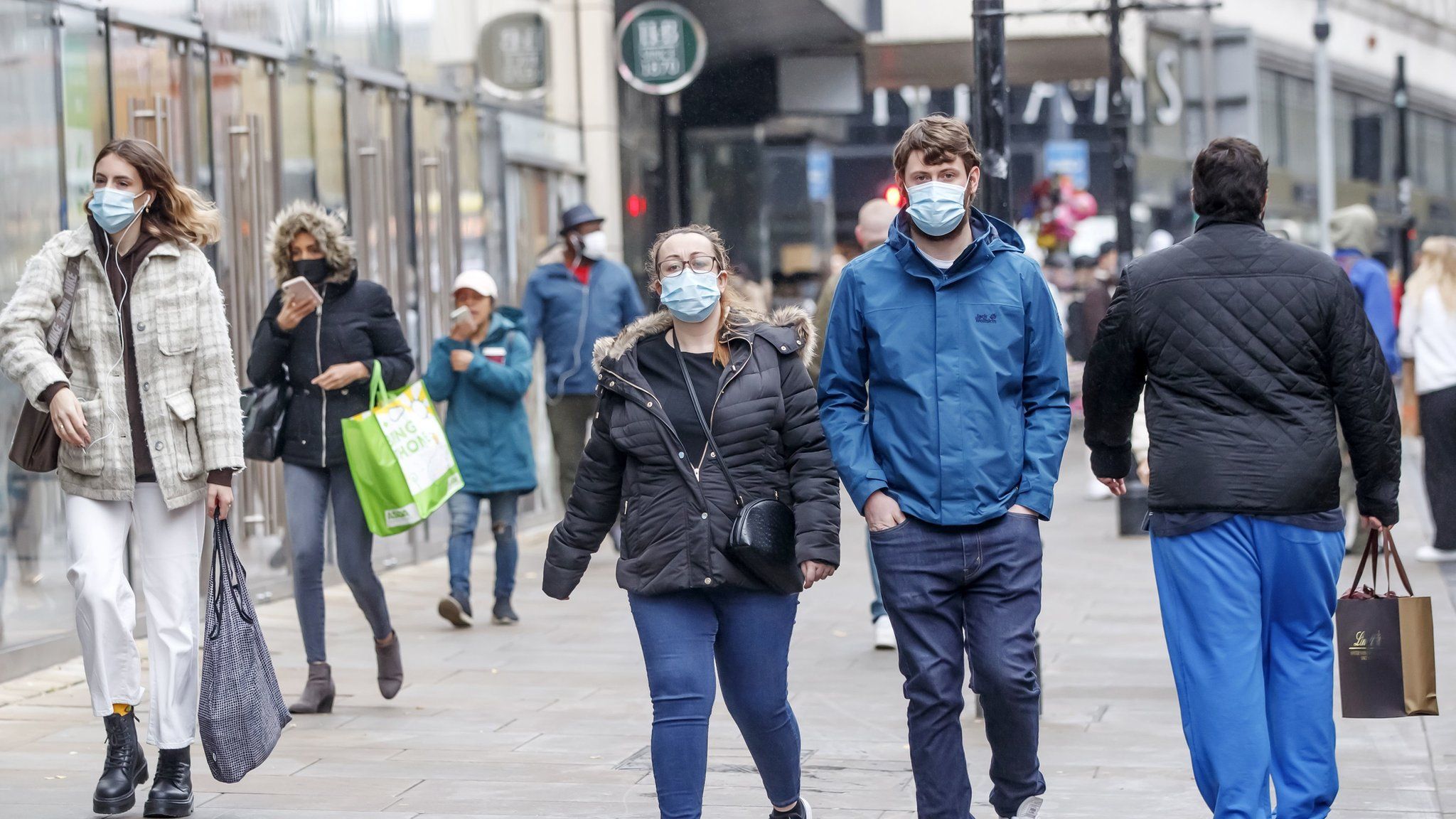 People wear face coverings in Manchester City Centre