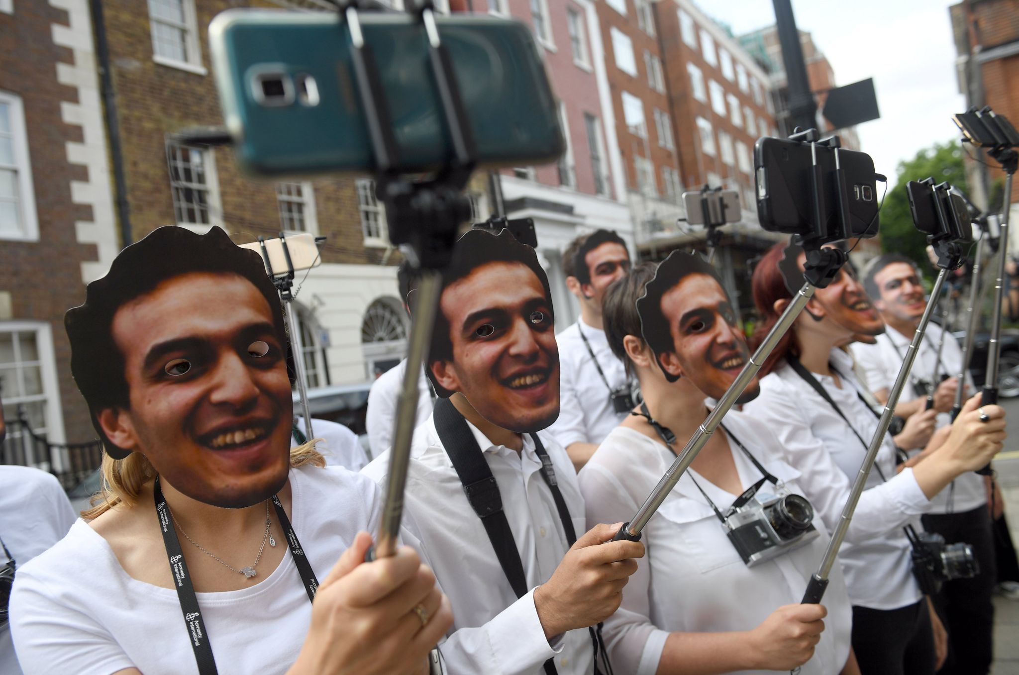 Demonstrators take selfies outside the Egyptian Embassy to bring attention to detained photojournalist Mahmoud Abu Zeid, also known as "Shawkan", in central London August 14, 2017.