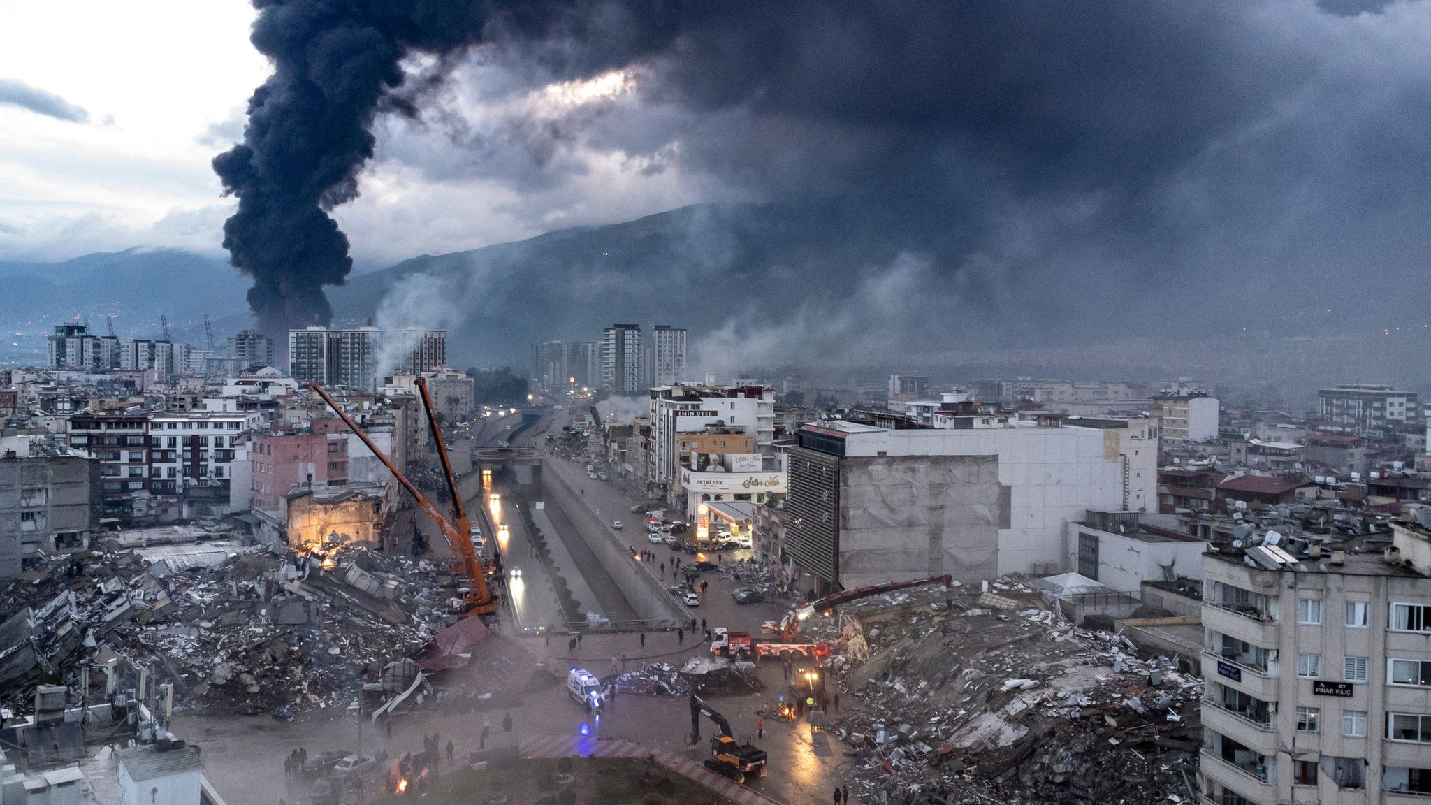 An aerial photo taken by a drone shows emergency personnel during a search and rescue operation at the site of a collapsed building after an earthquake in Iskenderun, district of Hatay, Turkey