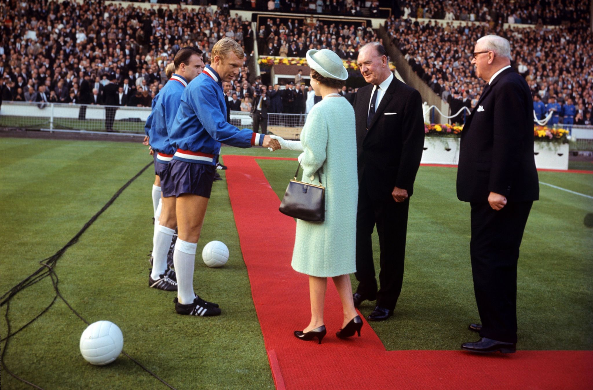 H.M. Queen meets England captain Bobby Moore before kick off at FIFA World Cup England 1966 - Opening Match - Group One - England v Uruguay - Wembley Stadium