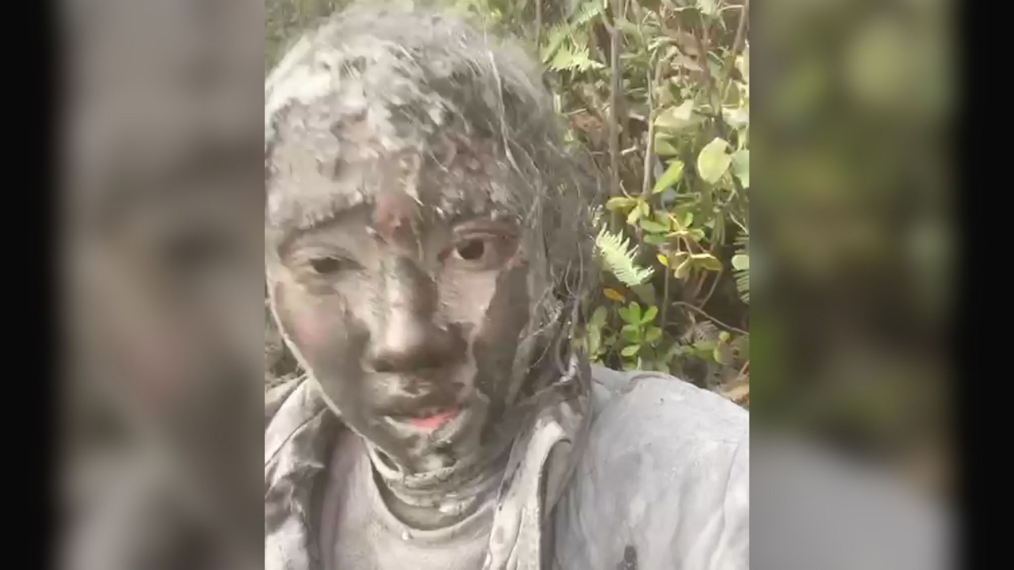 woman covered in mud looking ash