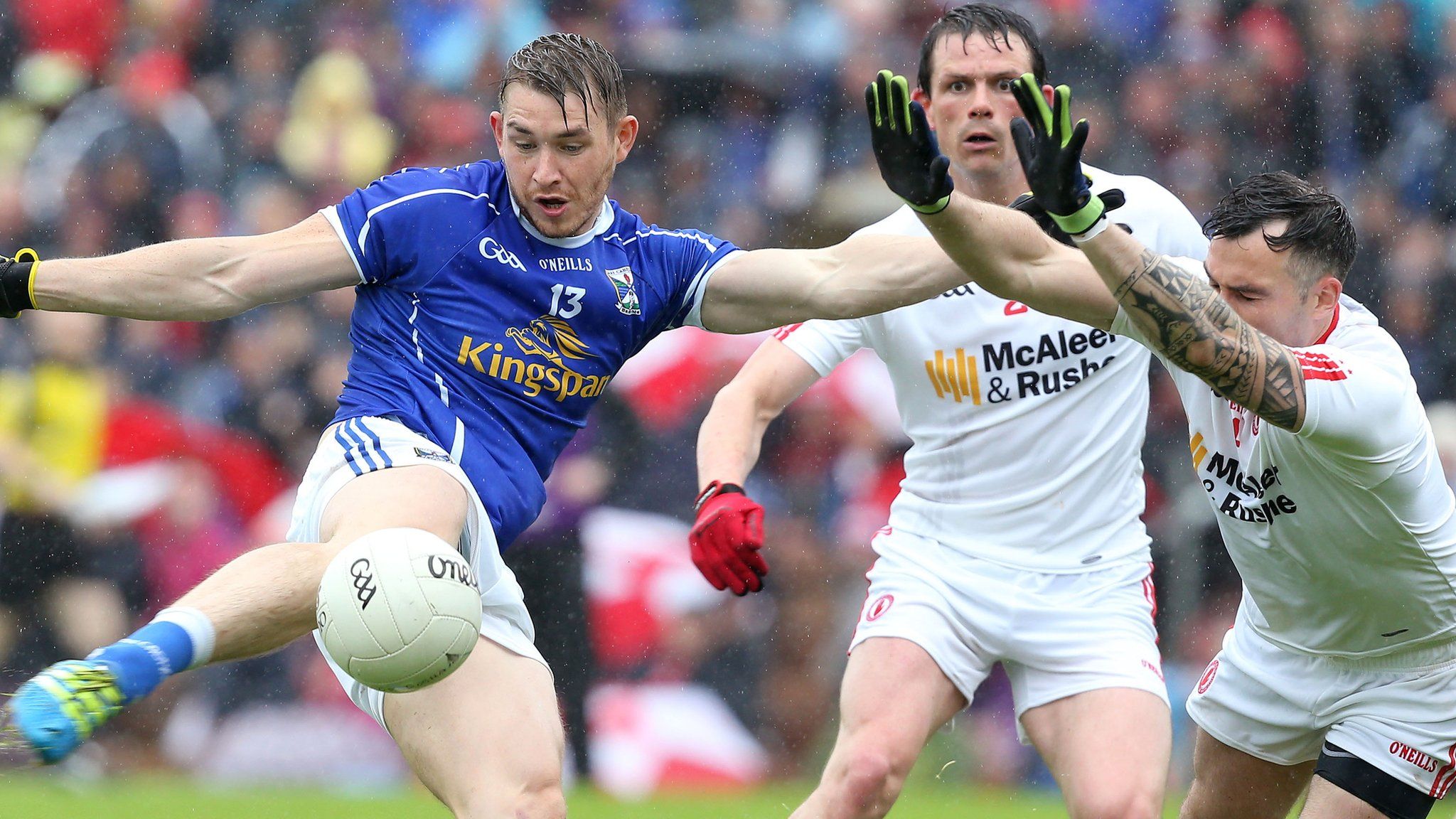 Cavan forward David Givney attempts to clear the block from Tyrone's Cathal McCarron