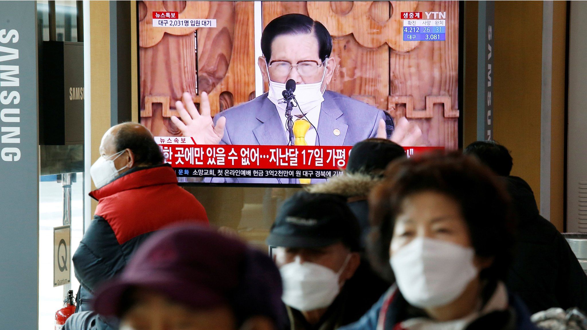 People watch a TV broadcasting a news report on a news conference held by Lee Man-hee, founder of the Shincheonji Church of Jesus the Temple of the Tabernacle of the Testimony, in Seoul, South Korea, March 2, 2020
