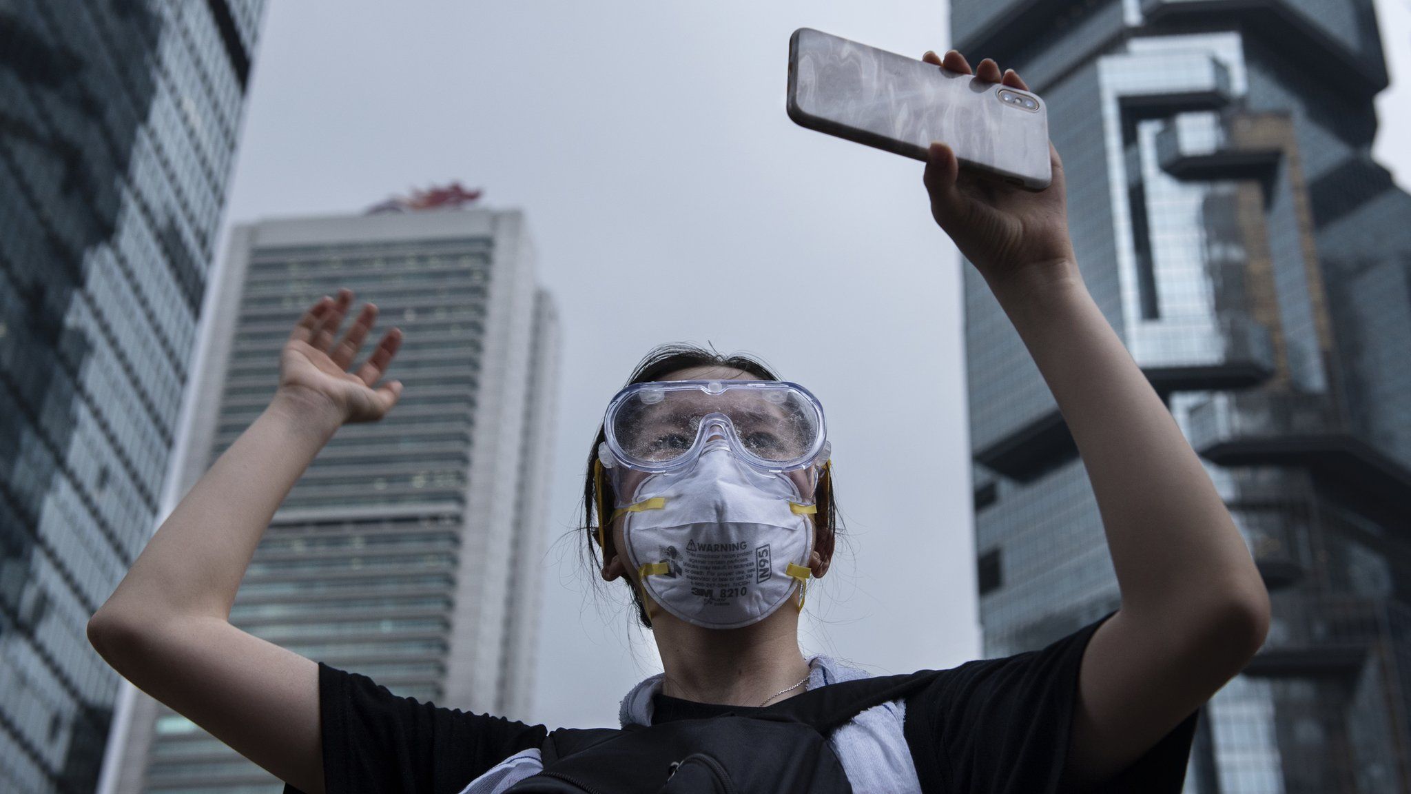 A protester holds a mobile phone