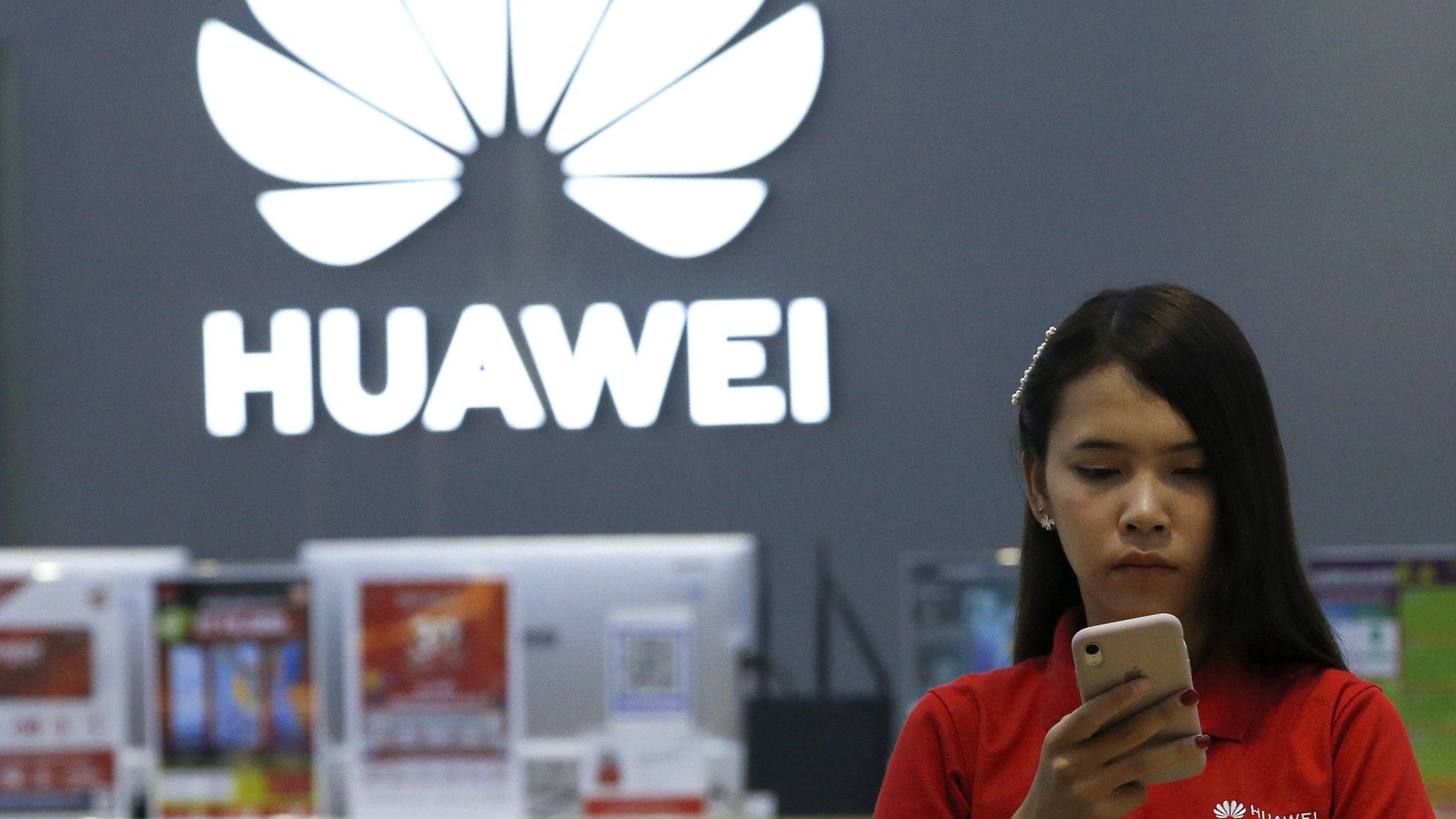 A Thai employee checks a Huawei smartphone at a Huawei store in Bangkok, Thailand, 21 May 2019.
