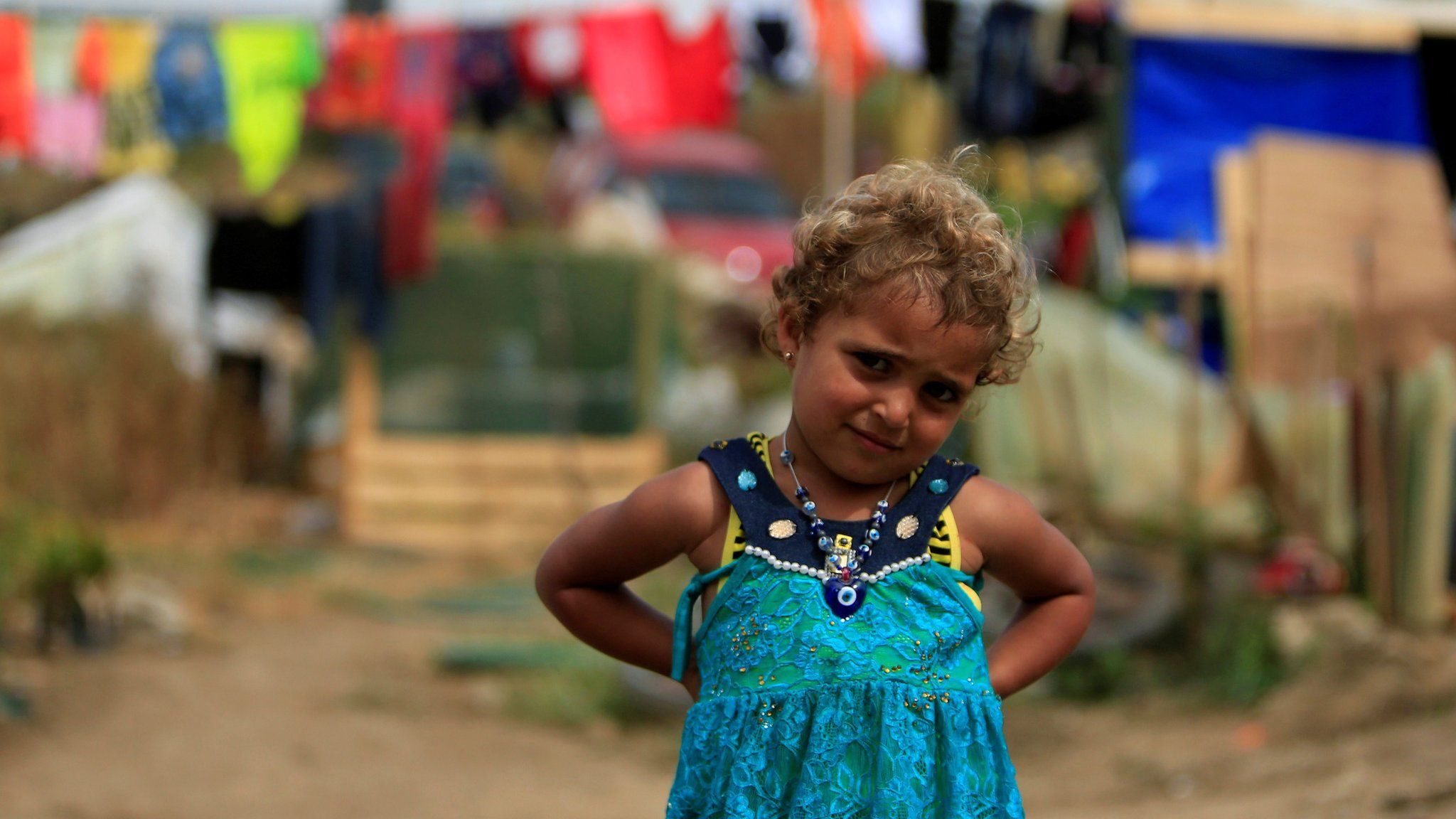A Syrian refugee girl poses outside tents during the visit of Dutch Prime Minister Mark Rutte to the refugee camp in Zahrani village, southern Lebanon (May 3, 2016)