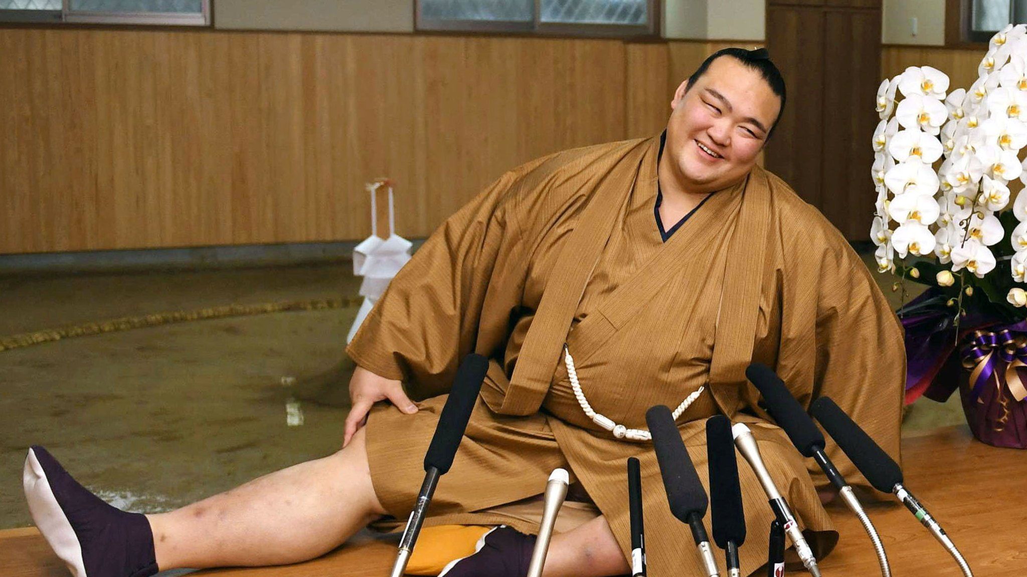 New Year Grand Sumo Tournament winner Kisenosato Yutaka stretches his legs during a press conference at his Tagonoura stable in Tokyo on 23 January 2017
