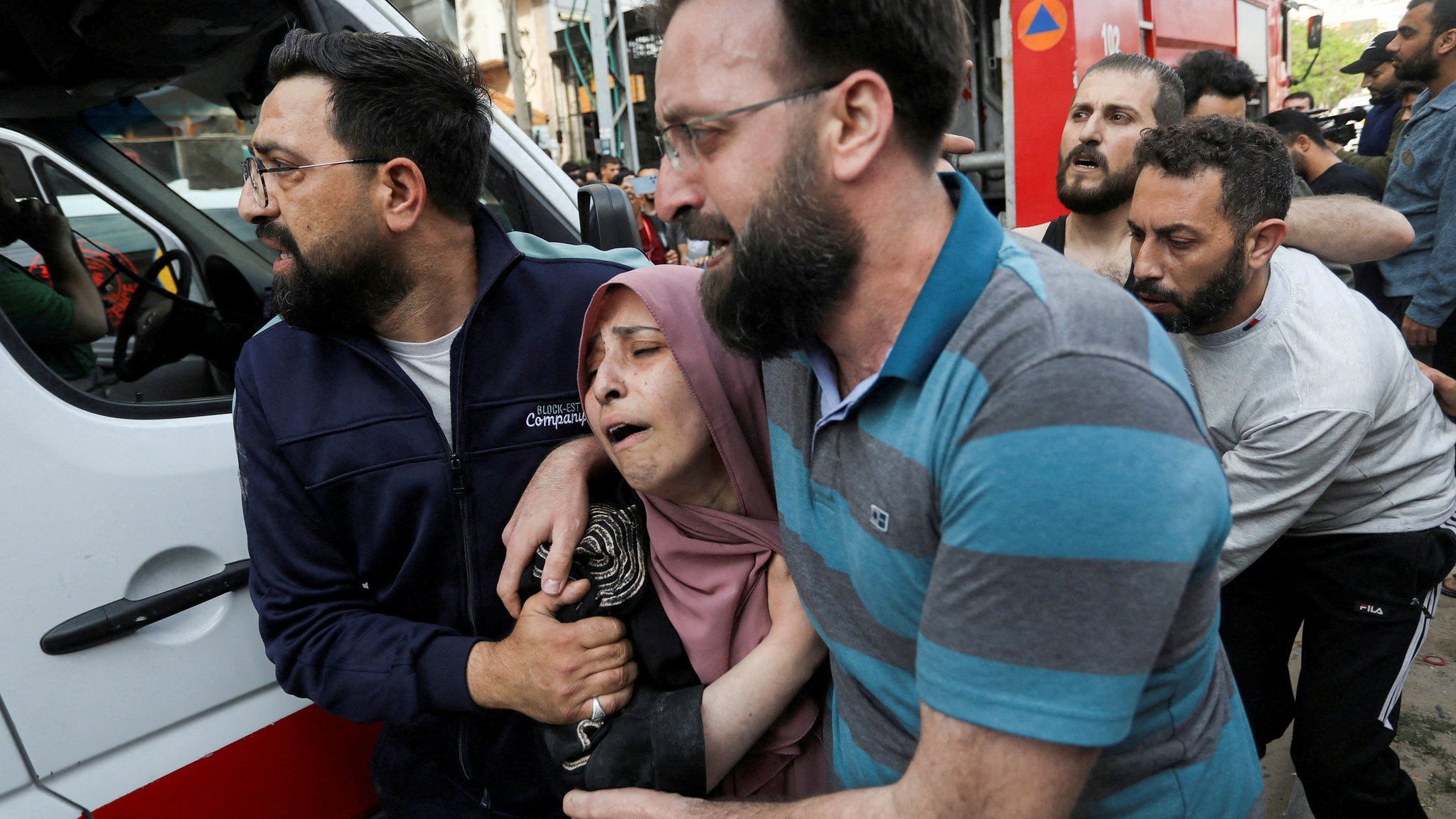 People react following an Israeli strike that killed senior Islamic Jihad commander Iyad al-Hassani in Gaza City (12 May 2023)