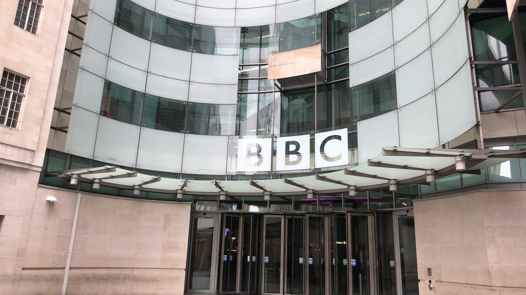 BBC logo and doors into New Broadcasting House in London