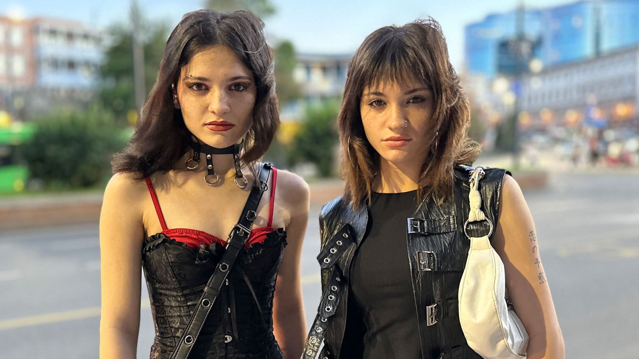 Amy Khvitia (L) and Ano Sartania (R) dressed in black standing in the street
