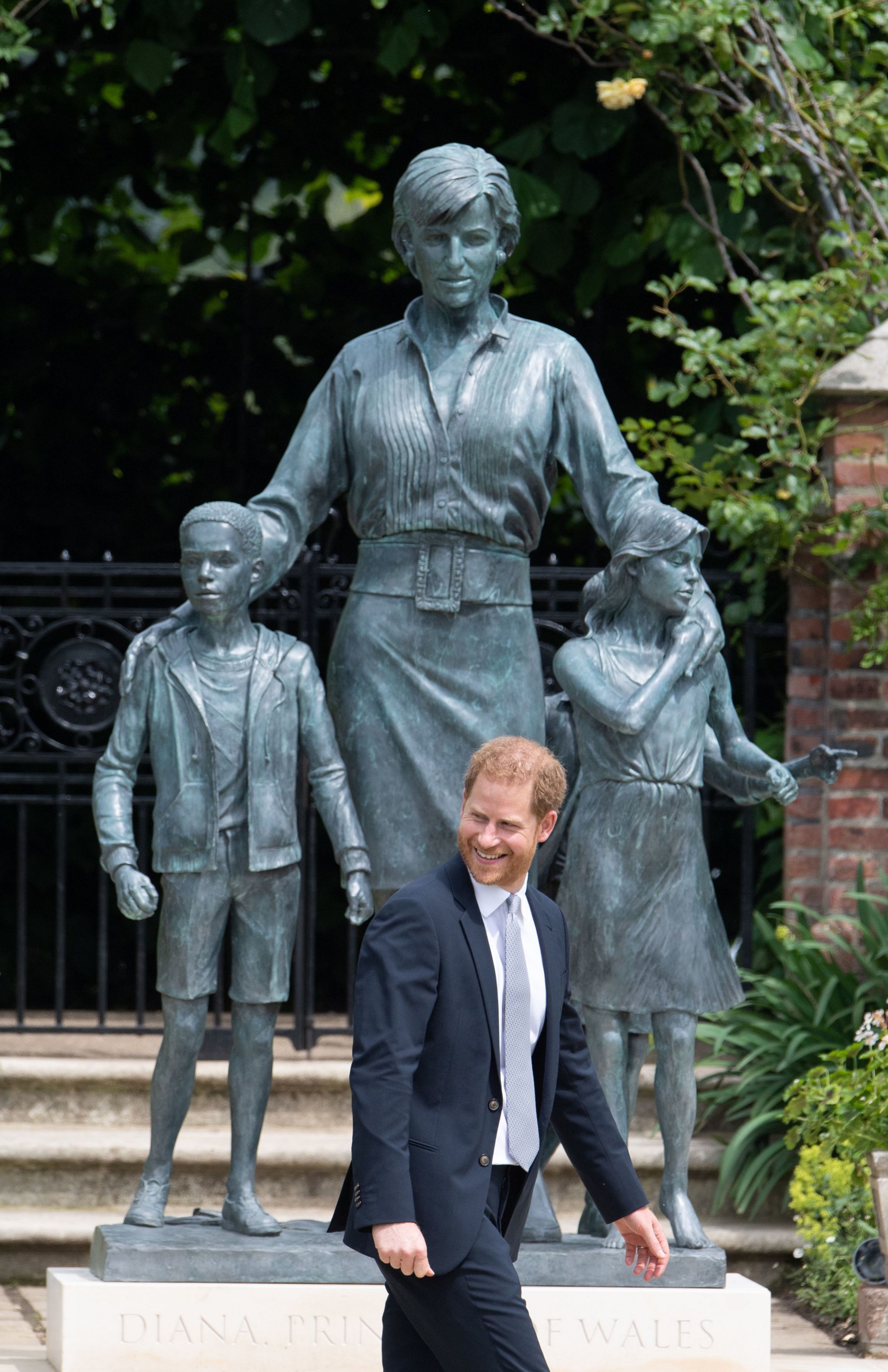 Prince Harry and Prince William next to the statue of Diana