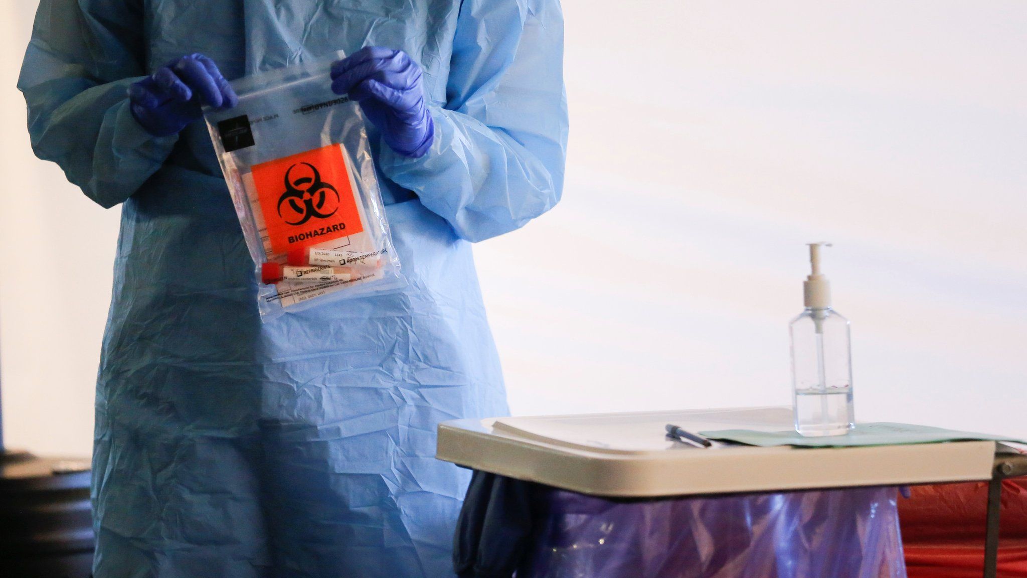 A nurse conducts a coronavirus test in Seattle
