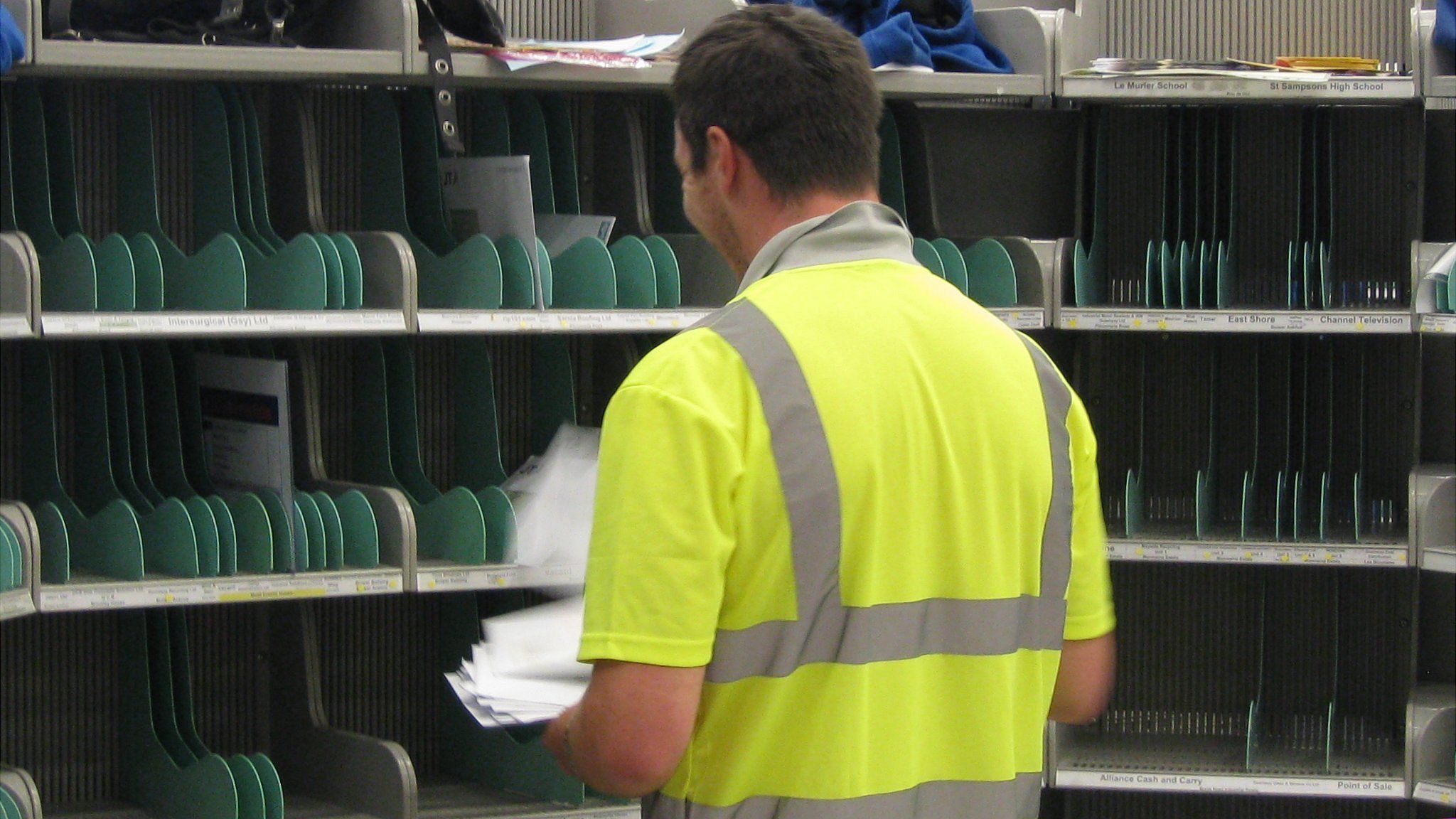 Guernsey postman sorting letters