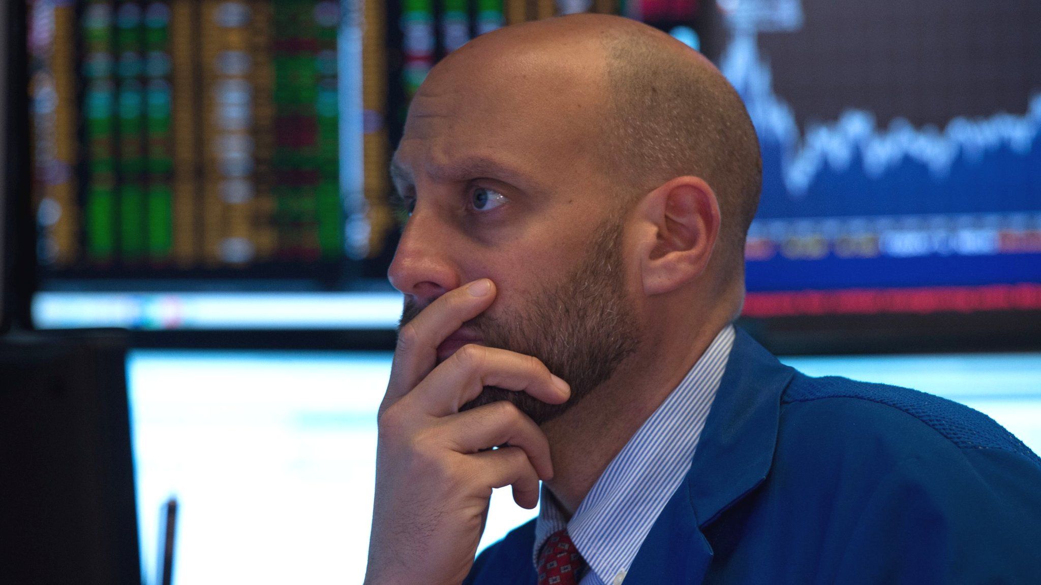 An investor looks at screens at the New York Stock exchange on 28 September 2017.