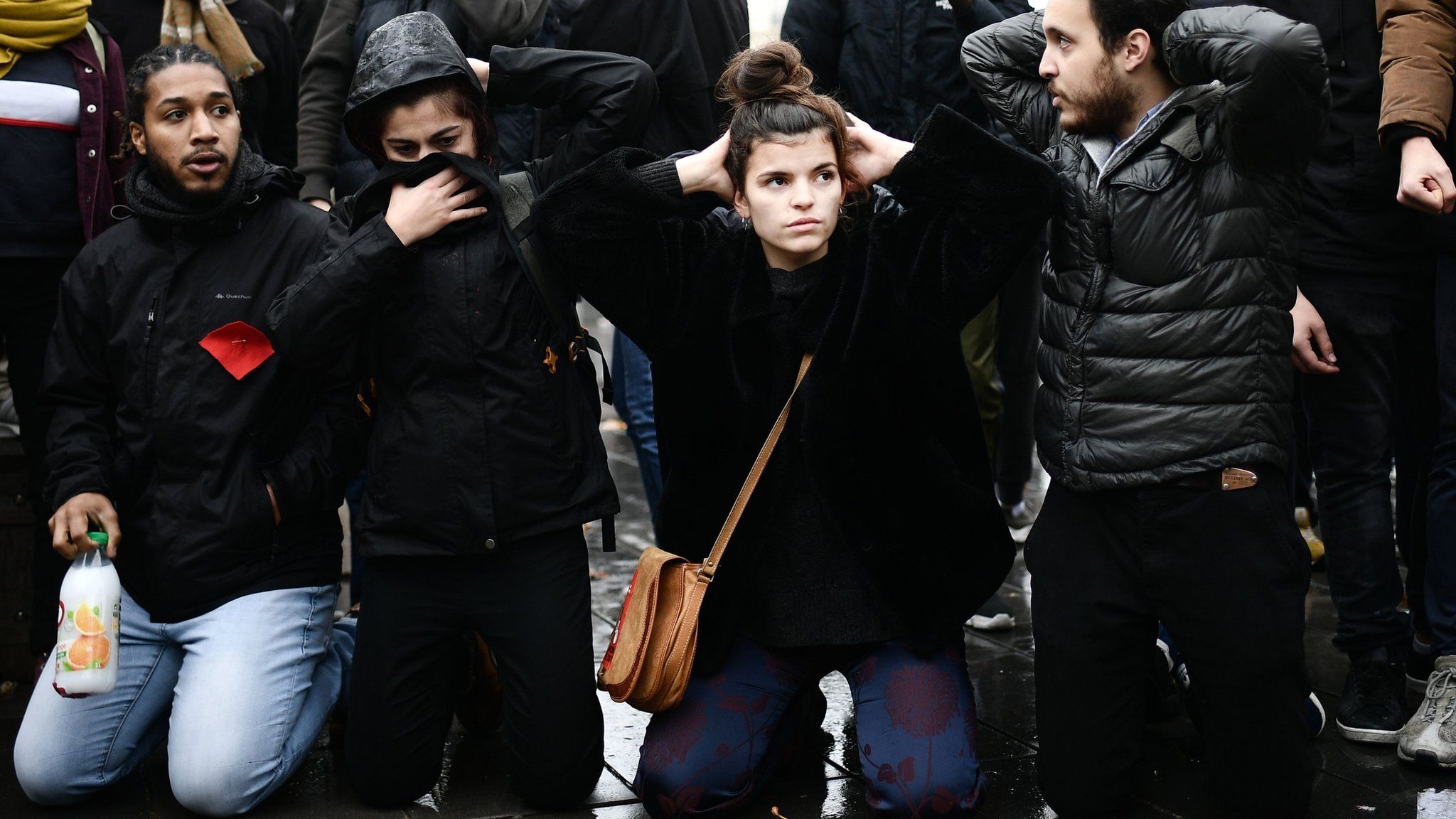 High school students re-enact yesterday's student arrest in Mantes-la-Jolie during a demonstration at the place de la Republique in Paris, 7 December 2018
