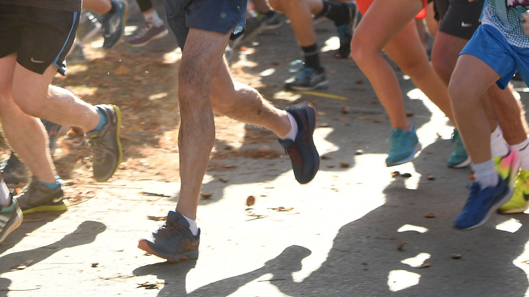 The legs of runners taking part in Parkrun