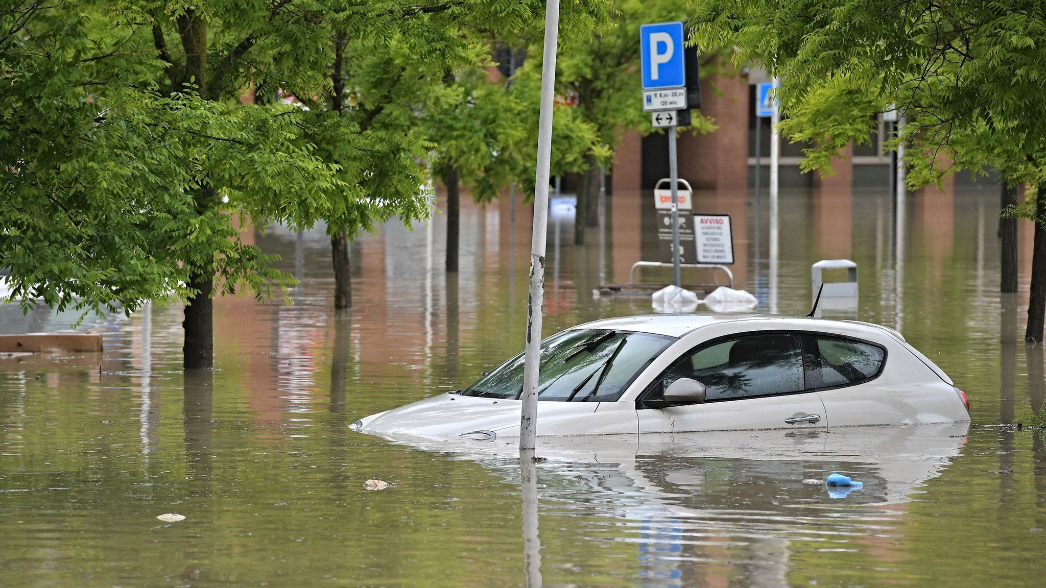 Car in a flooded supermarket area after heavy rains have caused major floodings in Cesena, Italy