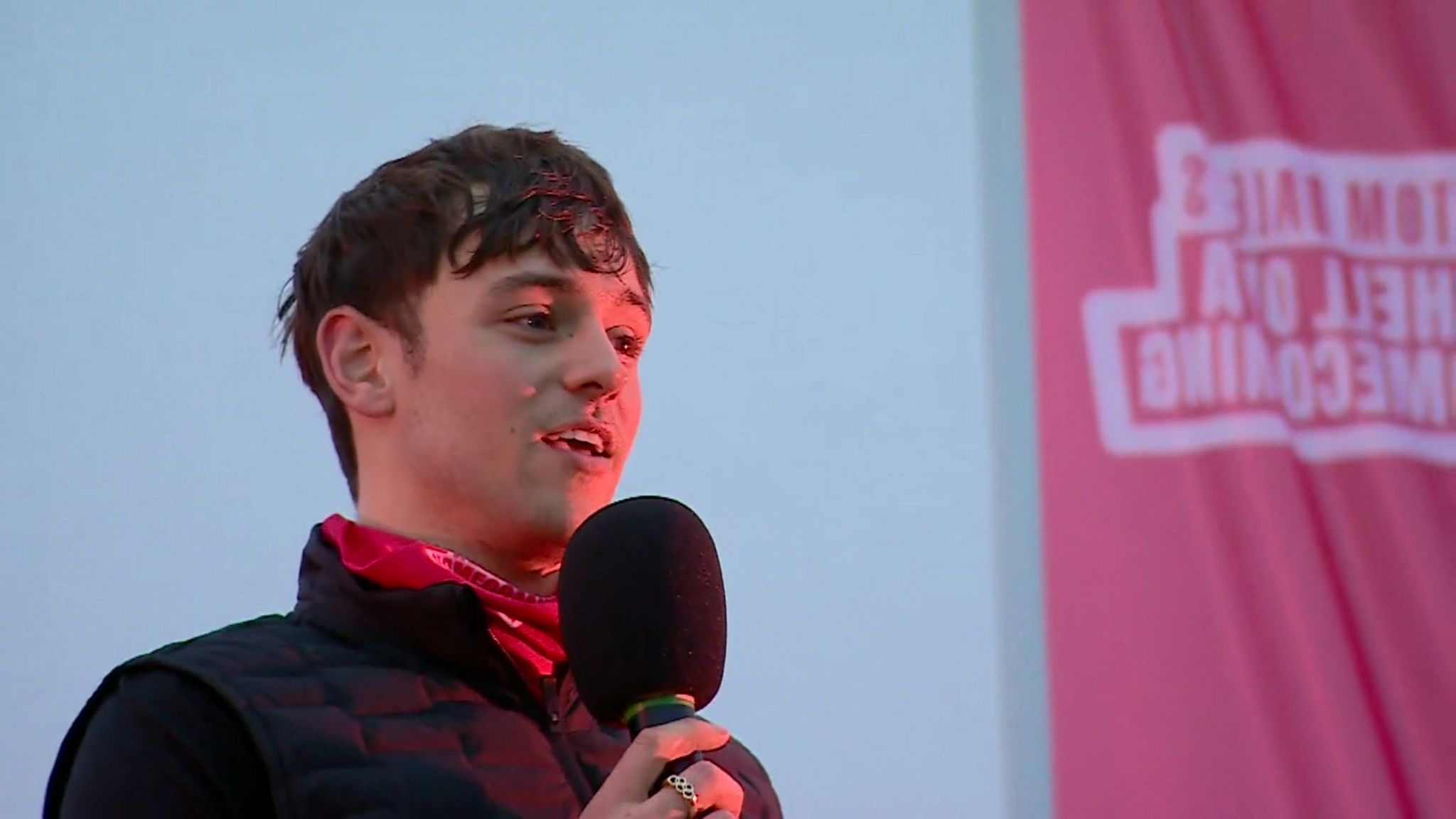 Tom Daley holding microphone