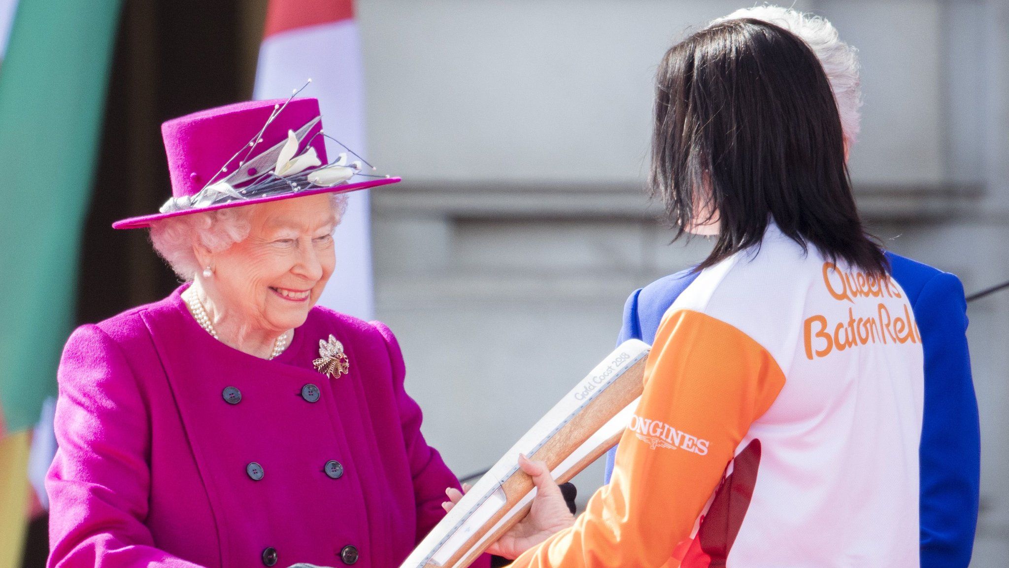 The Queen passes the Commonwealth Games baton to Australian cyclist Anna Meares